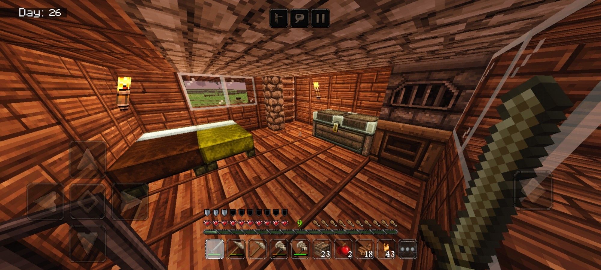 The image shows a first-person view inside a virtual environment, specifically from the game Minecraft. The scene is set inside a wooden house, with a bed on the left, a chest on the right, and a crafting table beside it. There are torches on the walls providing light, and a window shows an exterior area with vegetation.