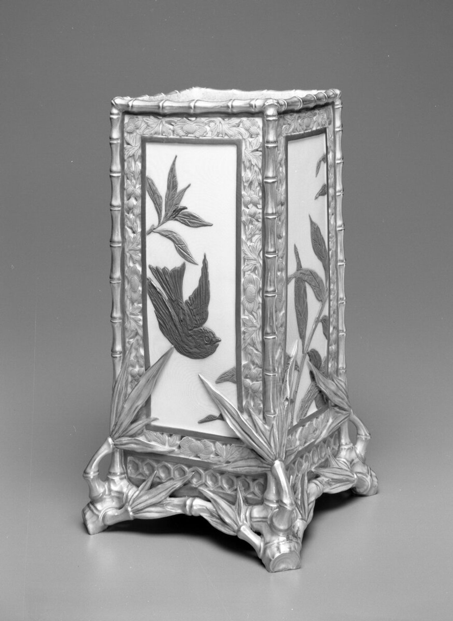 Diamond shaped vase with conforming bird and bamboo frieze decoration and bamboo feet.