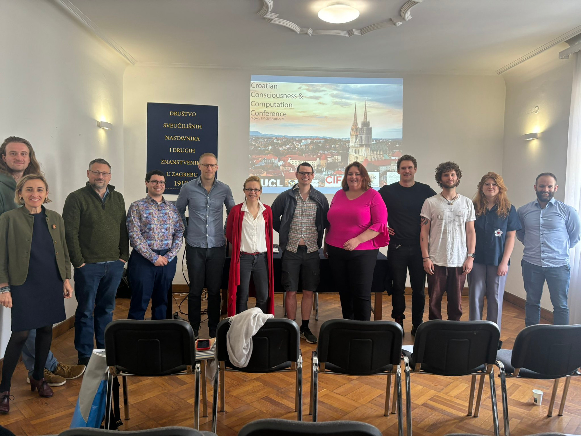 A photo of the speakers posing for a group photo.