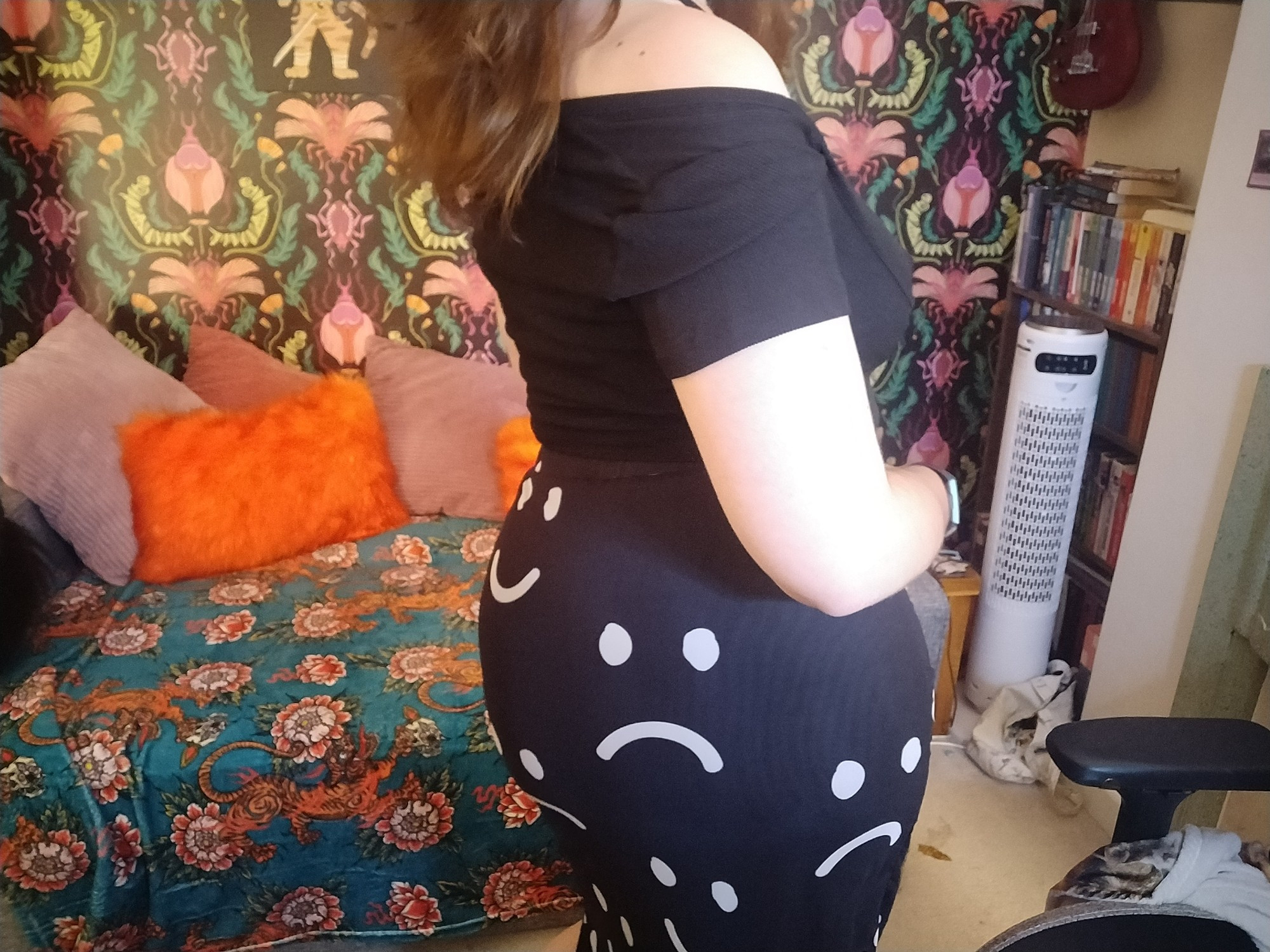 body photo of me wearing black buckle top and a black and white skirt with happy and sad faces on it. it's ass o'clock apparently! imagine this image without the fuck off fan and that leaf in front of it on the floor that my cat brought in. I don't have much alt text commentary for you guys today, it's been a long rough week and I'm gonna go see fweddy now awooooooo