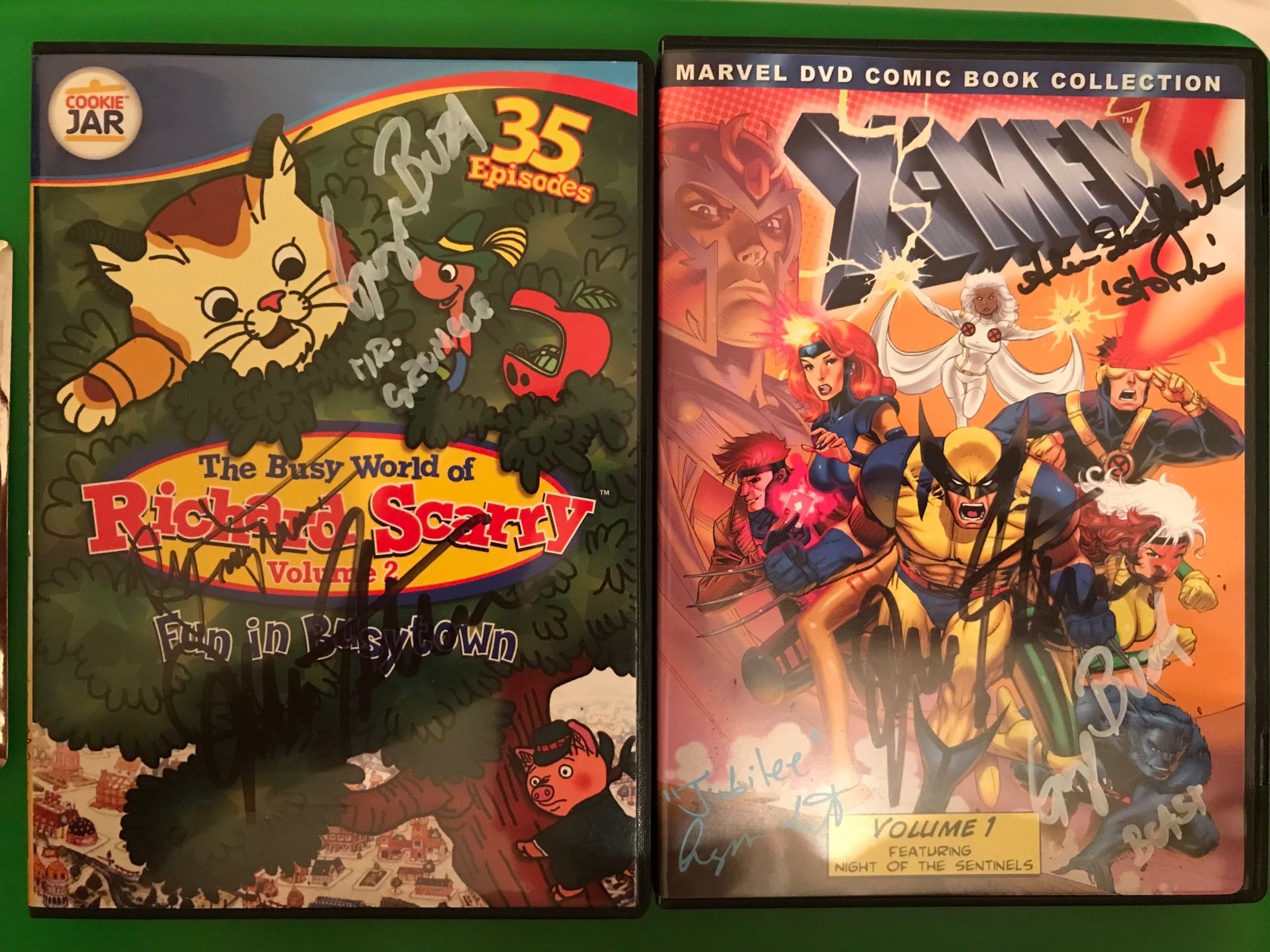 Left DVD cover is The Busy World of Richard Scarry vol. 2, signed by John Stocker, Alyson Court, and George Buza.  Right DVD cover is the X-Men: The Animated Series vol. 1 featuring Night of the Sentinels, signed by John Stocker/Toad, Alyson Court/Jubilee, George Buza/Beast, Alison Sealy-Smith/Storm, and Gui Agustini/Sunspot!