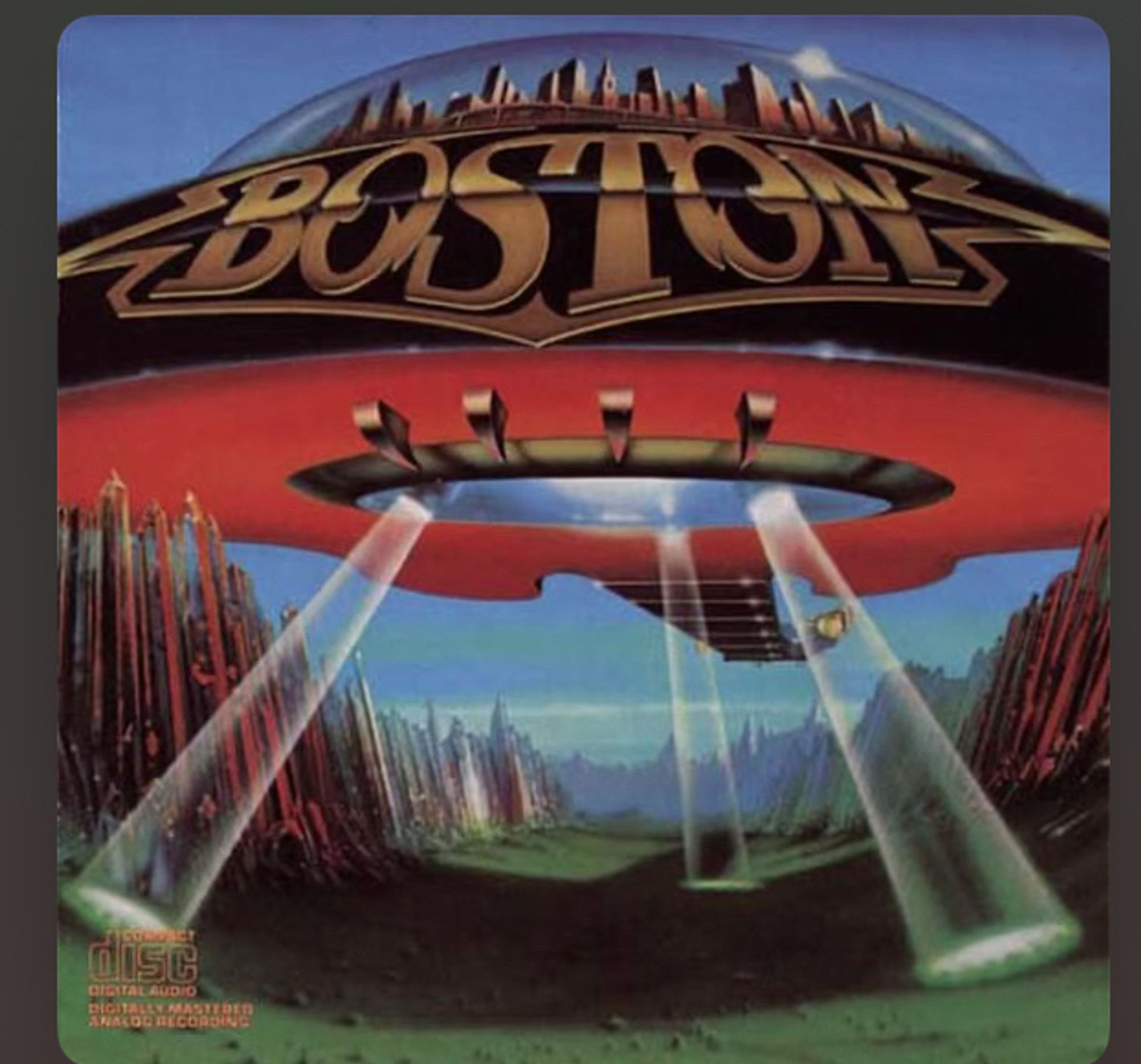 Boston cover. Giant guitar shaped UFO with an entire city ontop