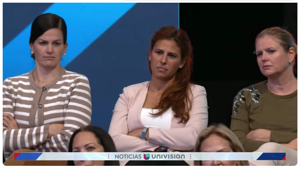 The Univision audience reacts to trump with disbelieving facial expressions and folded arms