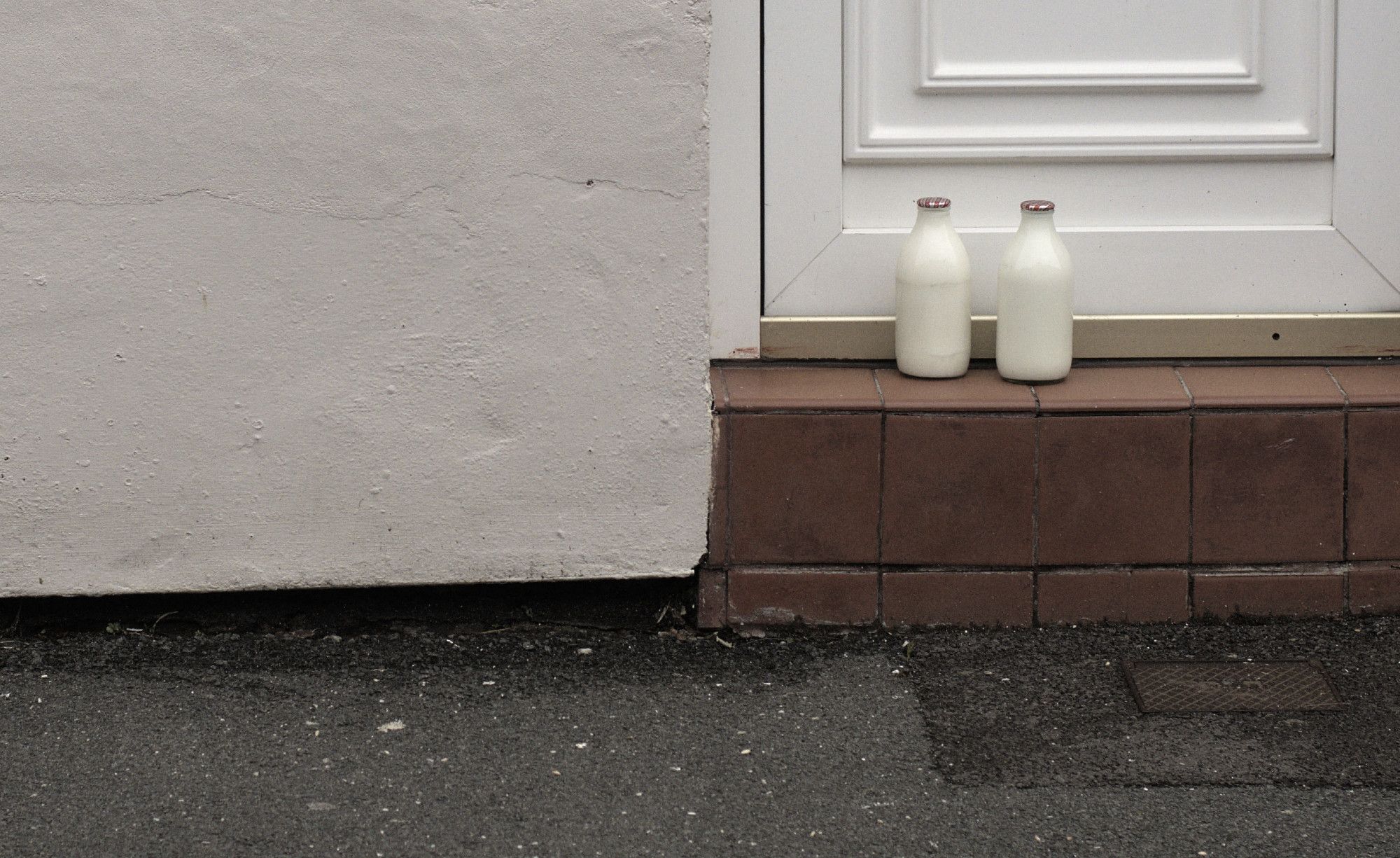 Red topped milk bottles on the doorstep