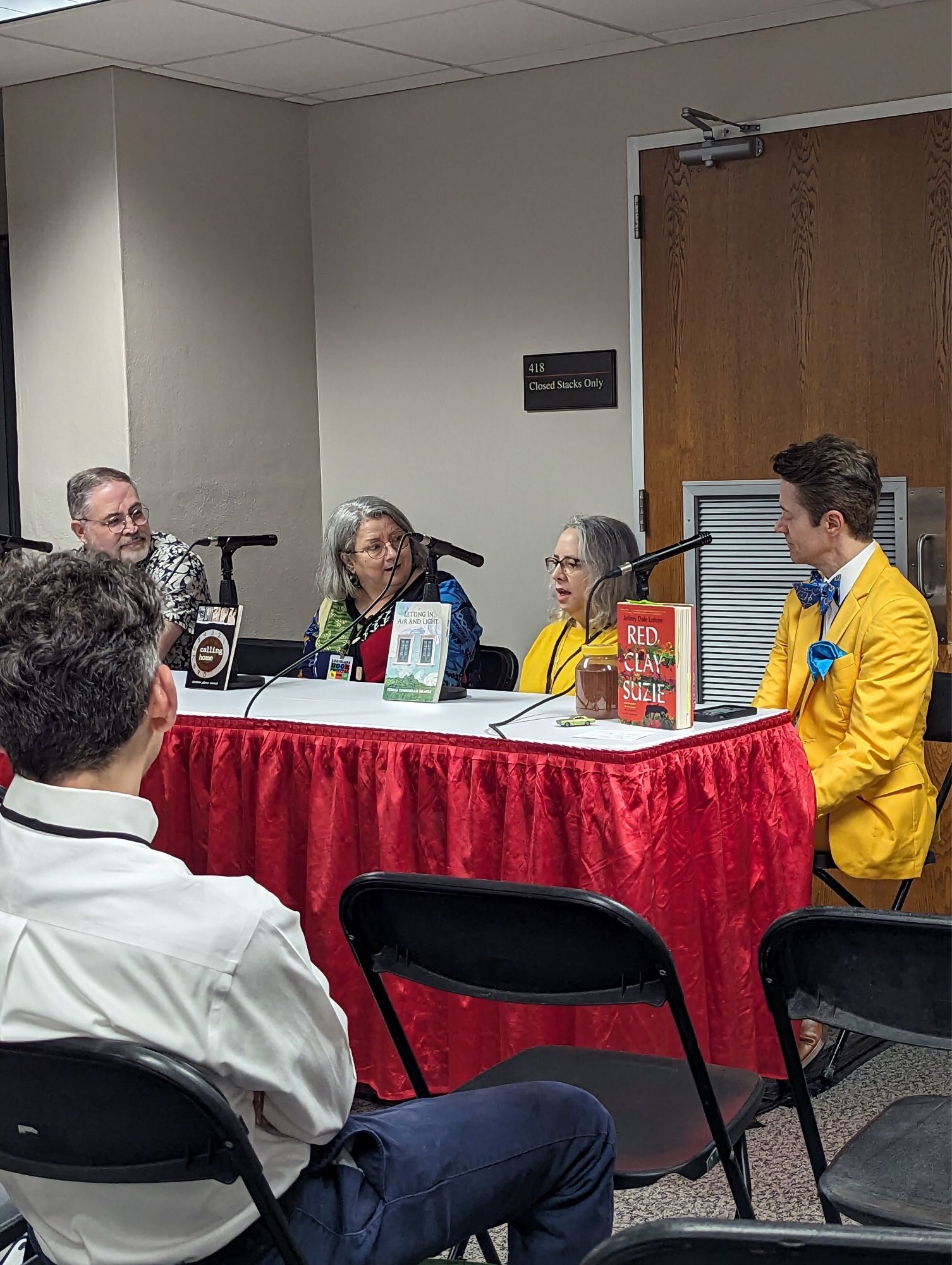 Four people at a table with microphones