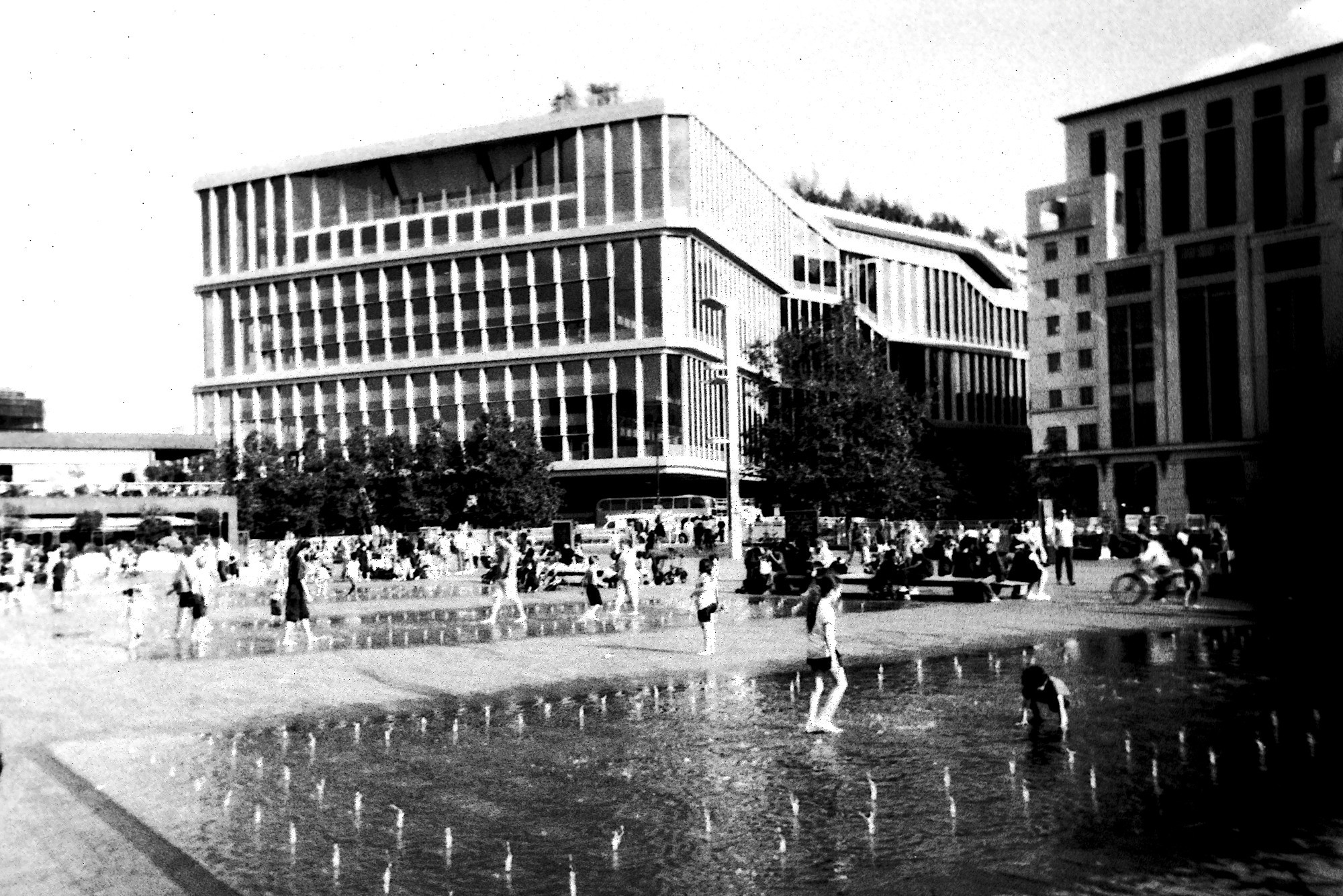 Kids playing in the fountains at Granary Square, Kings Cross, London.