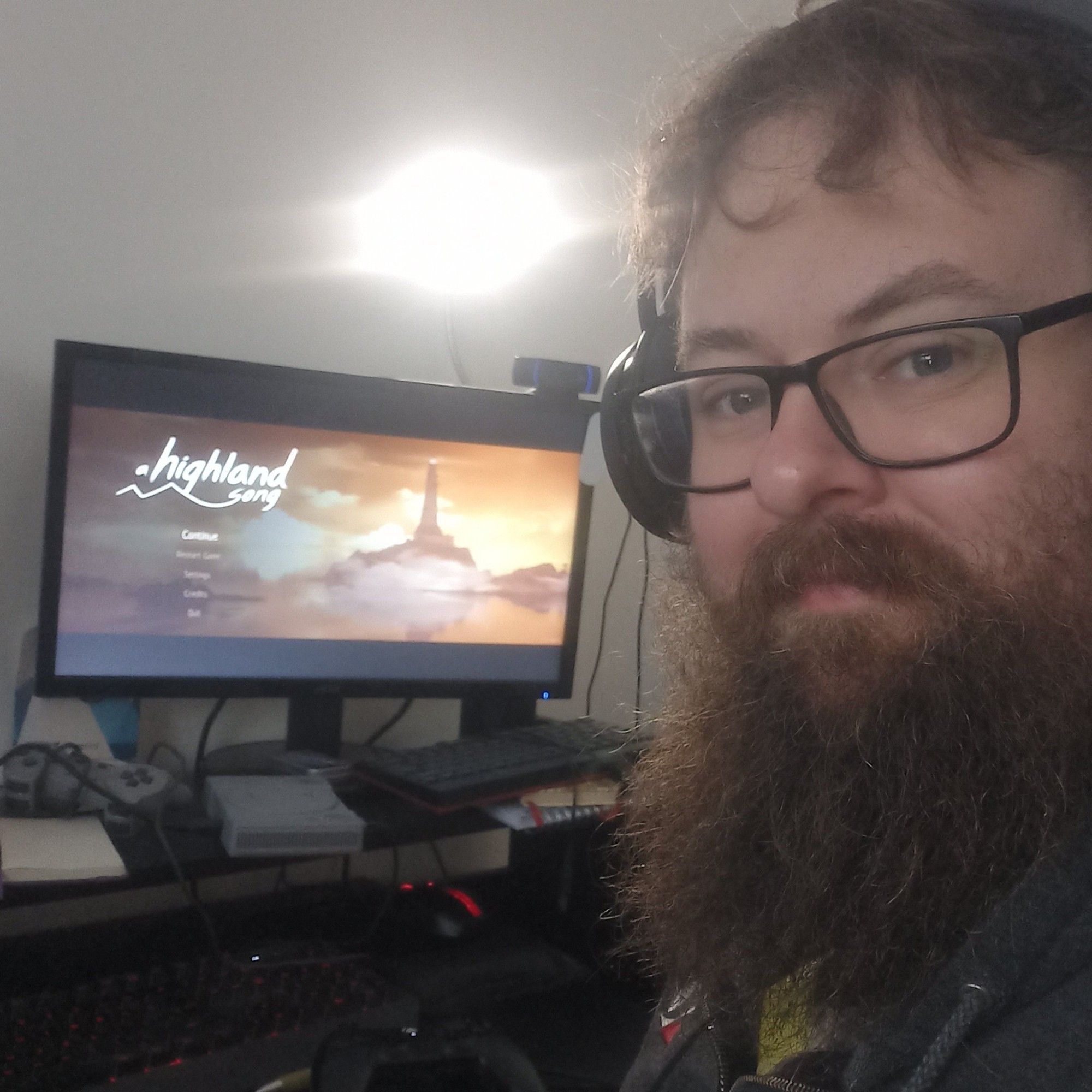 Rhys in front of the title screen for A Highland Song