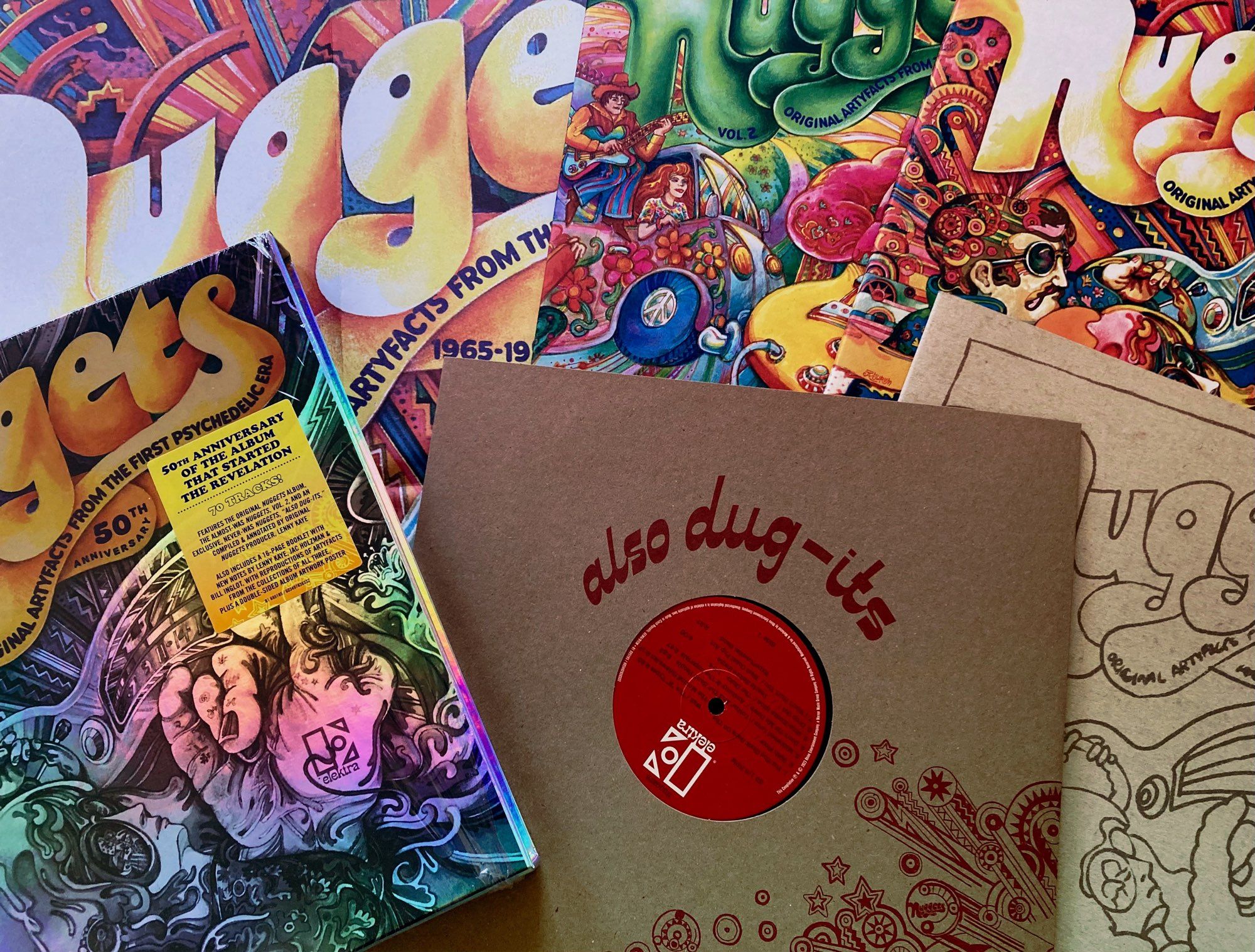 The contents of the recent Nuggets 50th anniversary edition box. 2 double lps, a single lp, a poster and booklet