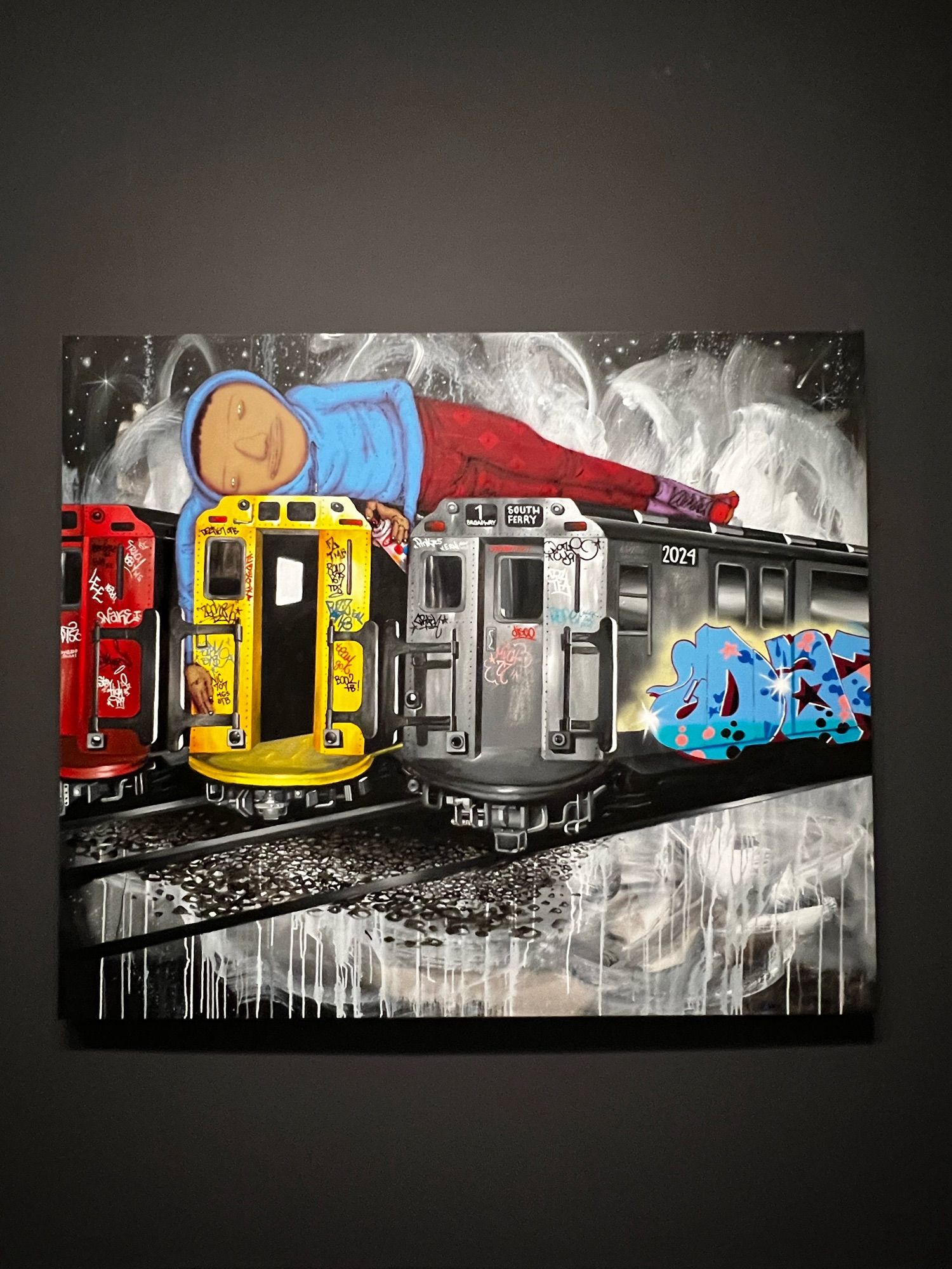 An Osgemeos painting of three graffitied subway cars