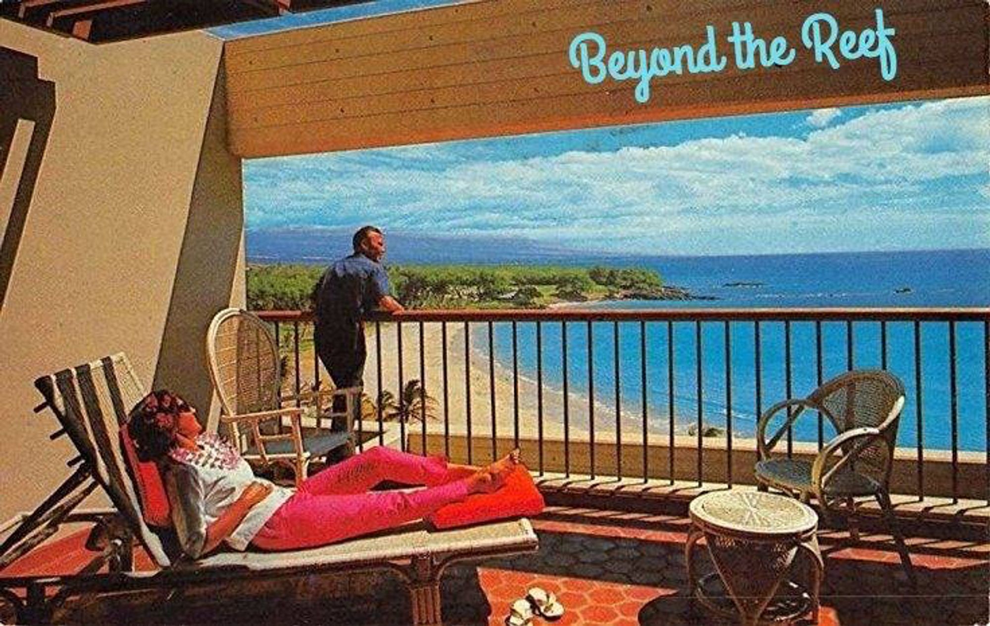 An early 1970s postcard showing a woman lounging on a hotel balcony while a man leans against the railing observing the seascape stretched out before hime. Rattan furniture is visible in the foreground.