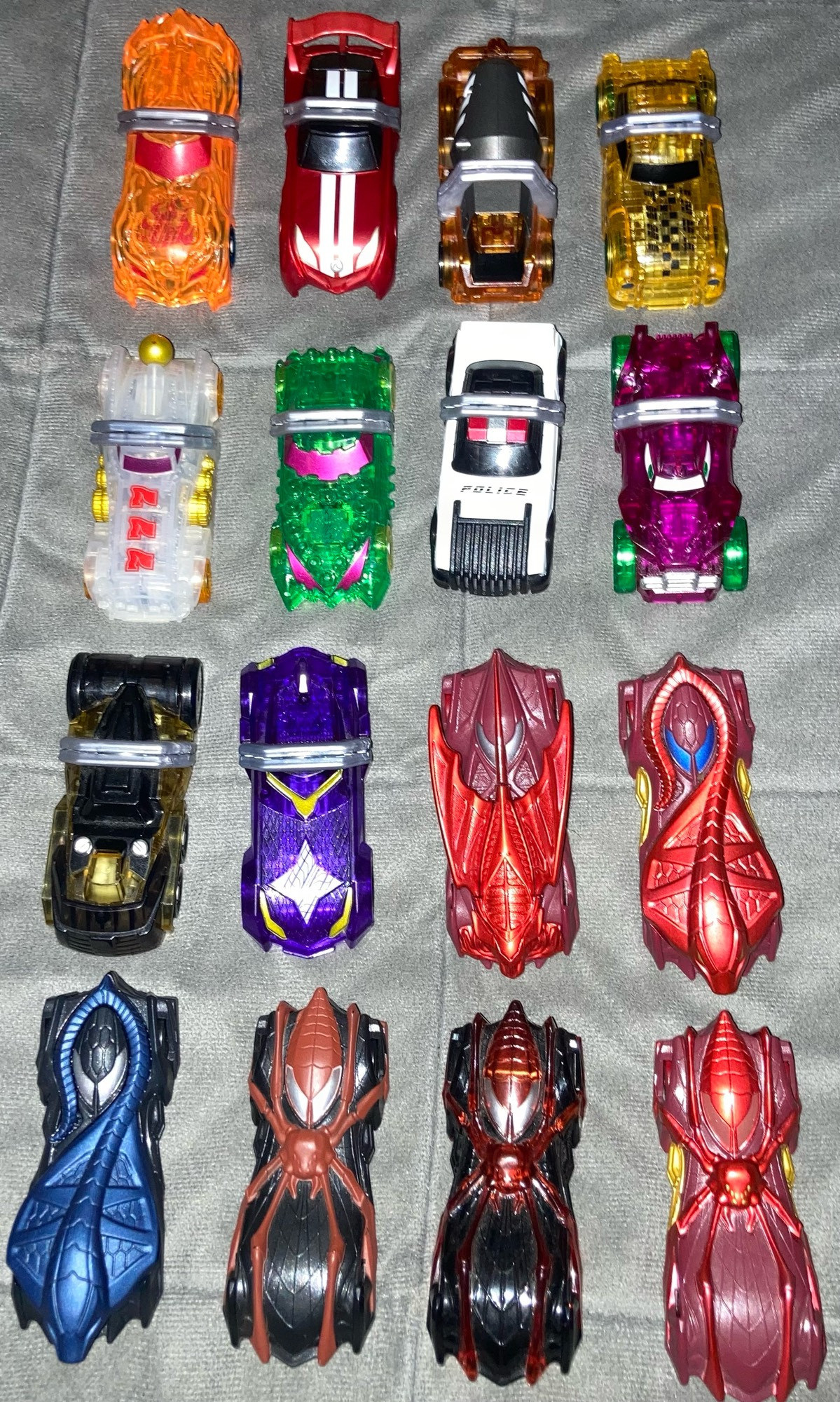 Several Shift Cars from Kamen Rider Drive, along with a few of Mashin Chaser's Viral Cores