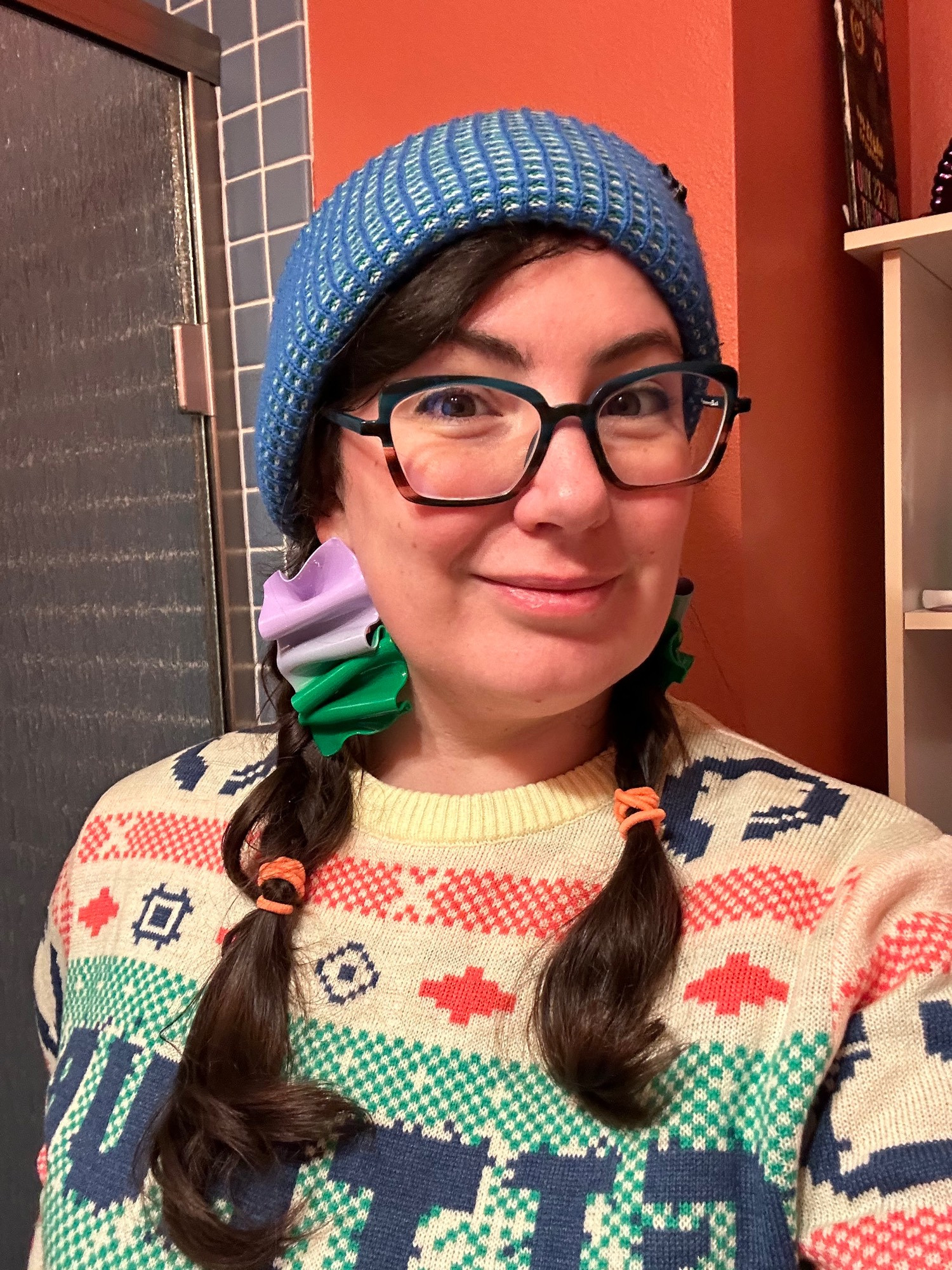 Lady in a sweater and hat, sweater says GITHUB