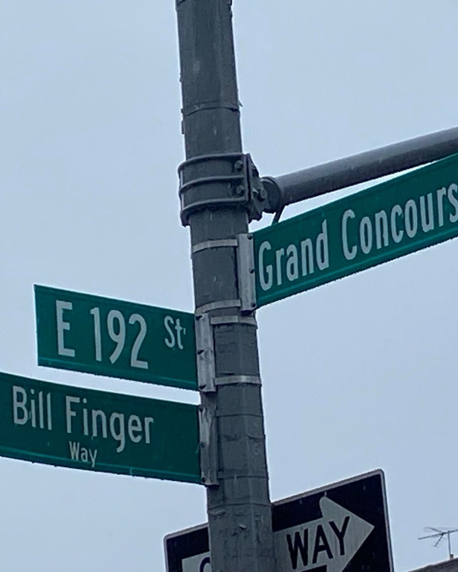 Street signs at the intersection of E192 st, also named Bill Finger Way, and Grand Concourse