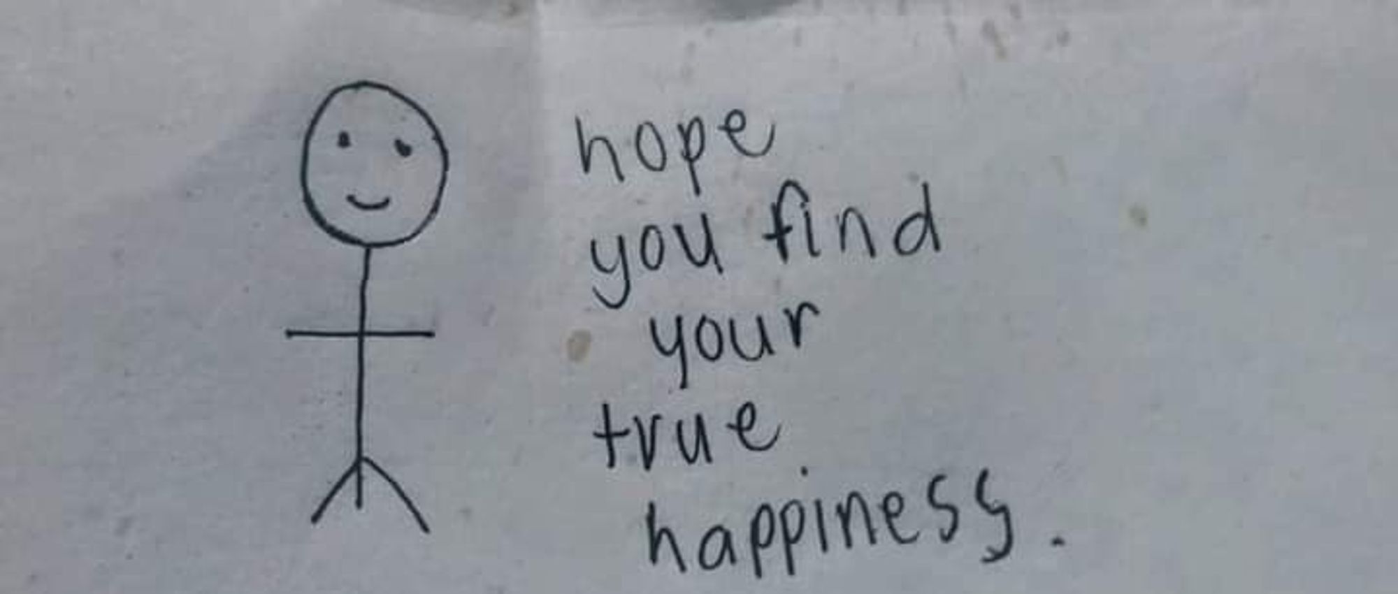 une image gris foncé : un bonhomme bâton qui sourit : "hope you find your true happiness"