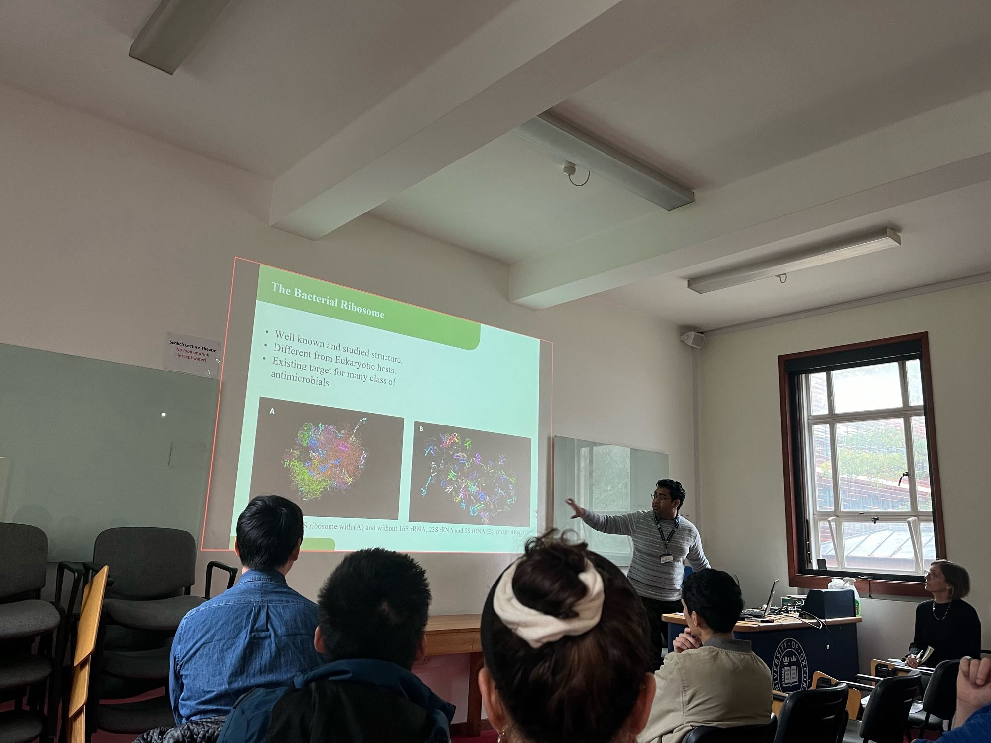 Priyanshu presenting his work on bacterial ribosomes to a room of people