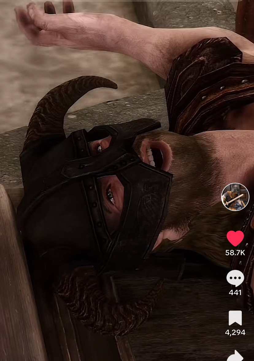 The Dragonborn, a beefy dude in a breastplate & horned helm, laying on his back, looking up, with O face 😂