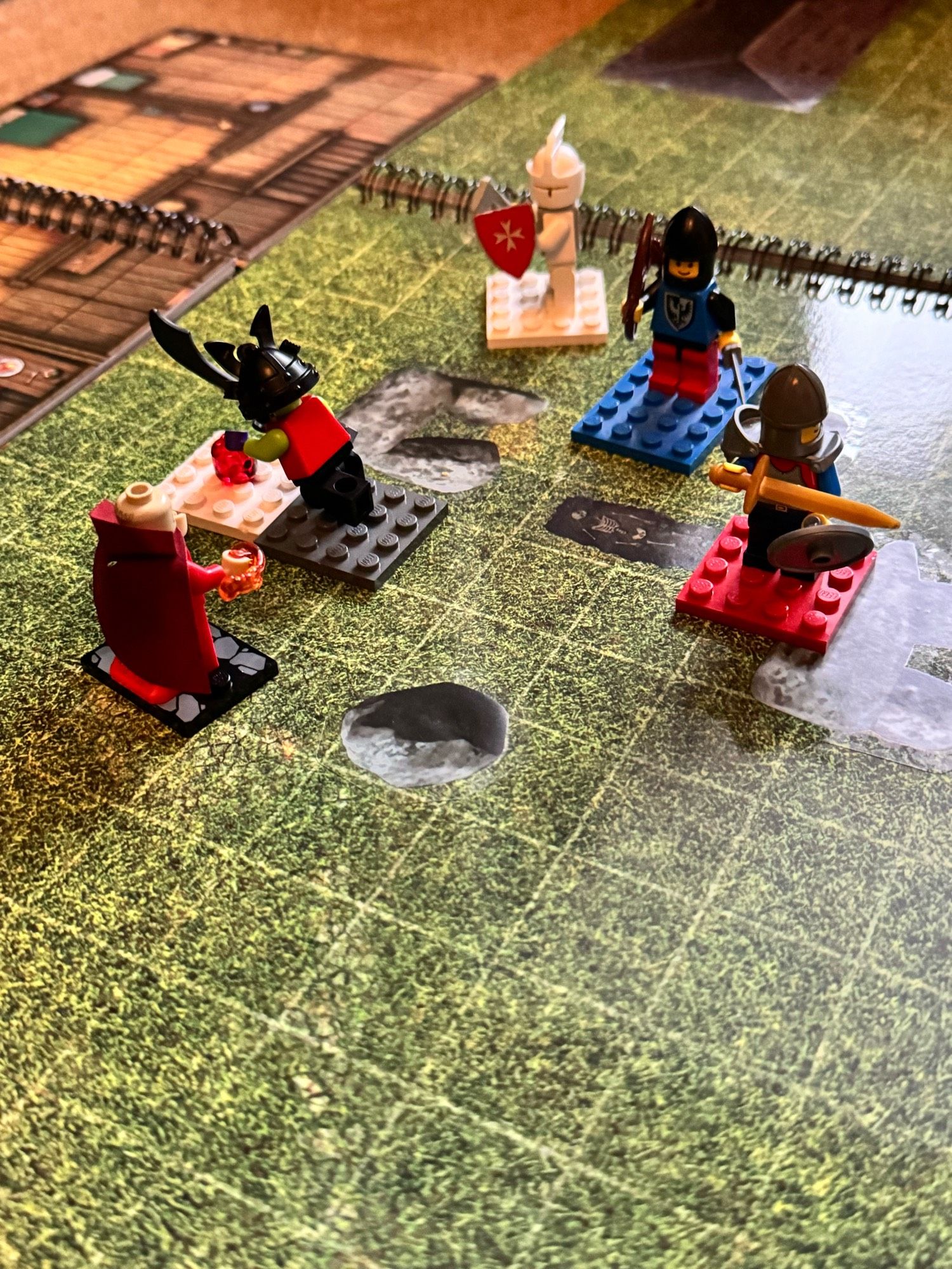 The minifigs battle a sorcerer near a stone circle.