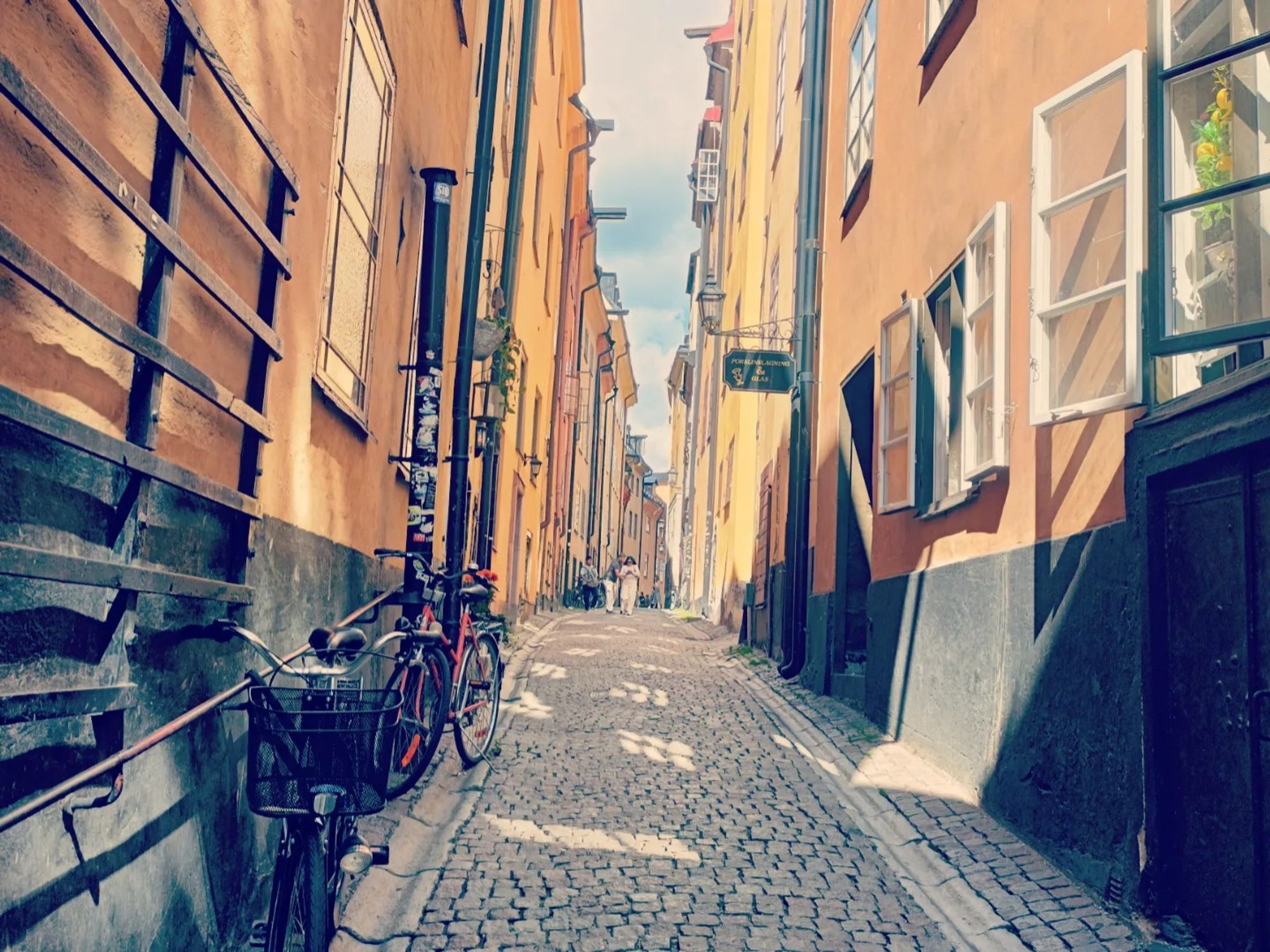 A narrow street with jellow colored houses in the old town centre in Stockholm