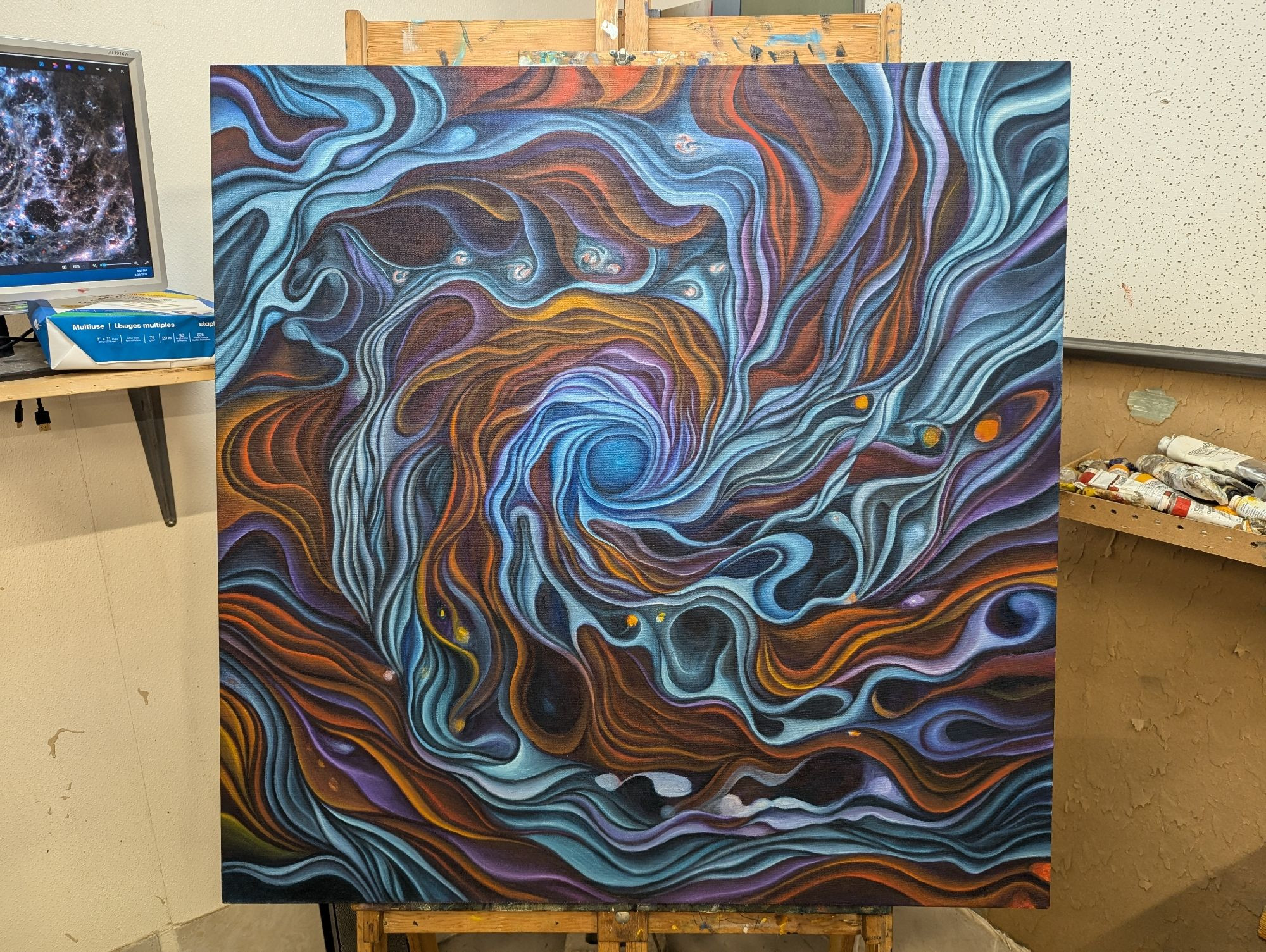 WIP painting of a galaxy with swirls of white blue oranges and red