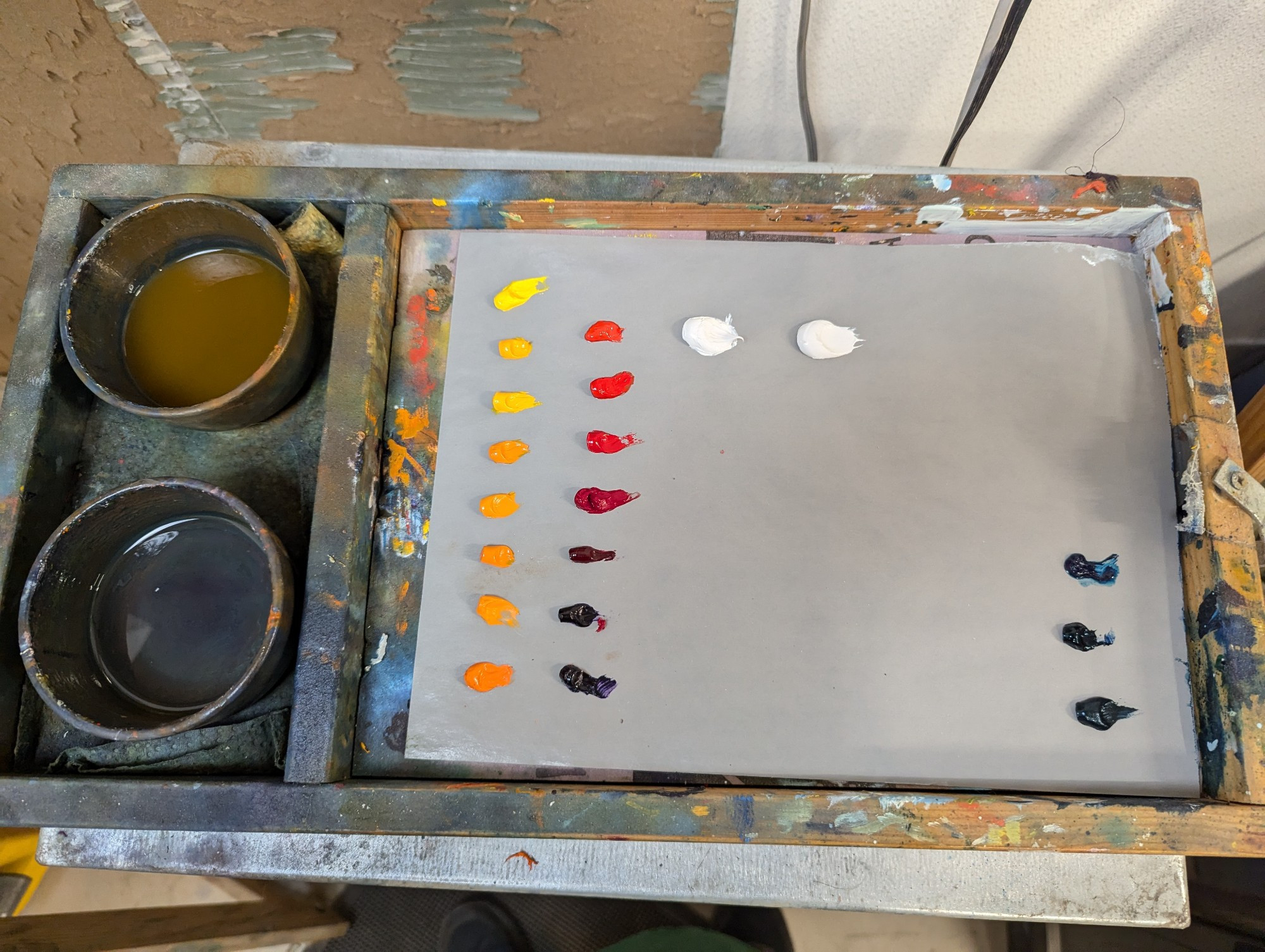 Pallette pad with new paints with solvent cups on the left. 