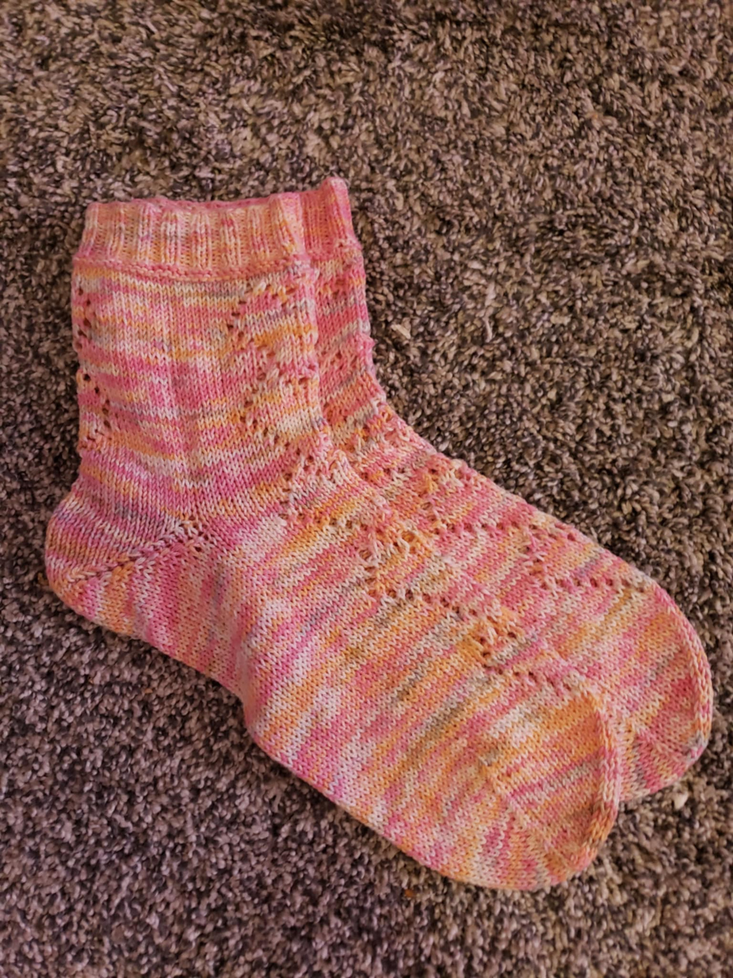 Same pair of socks but from the side view, showing the heel and how there are hearts on the back of the ankles as well as the front