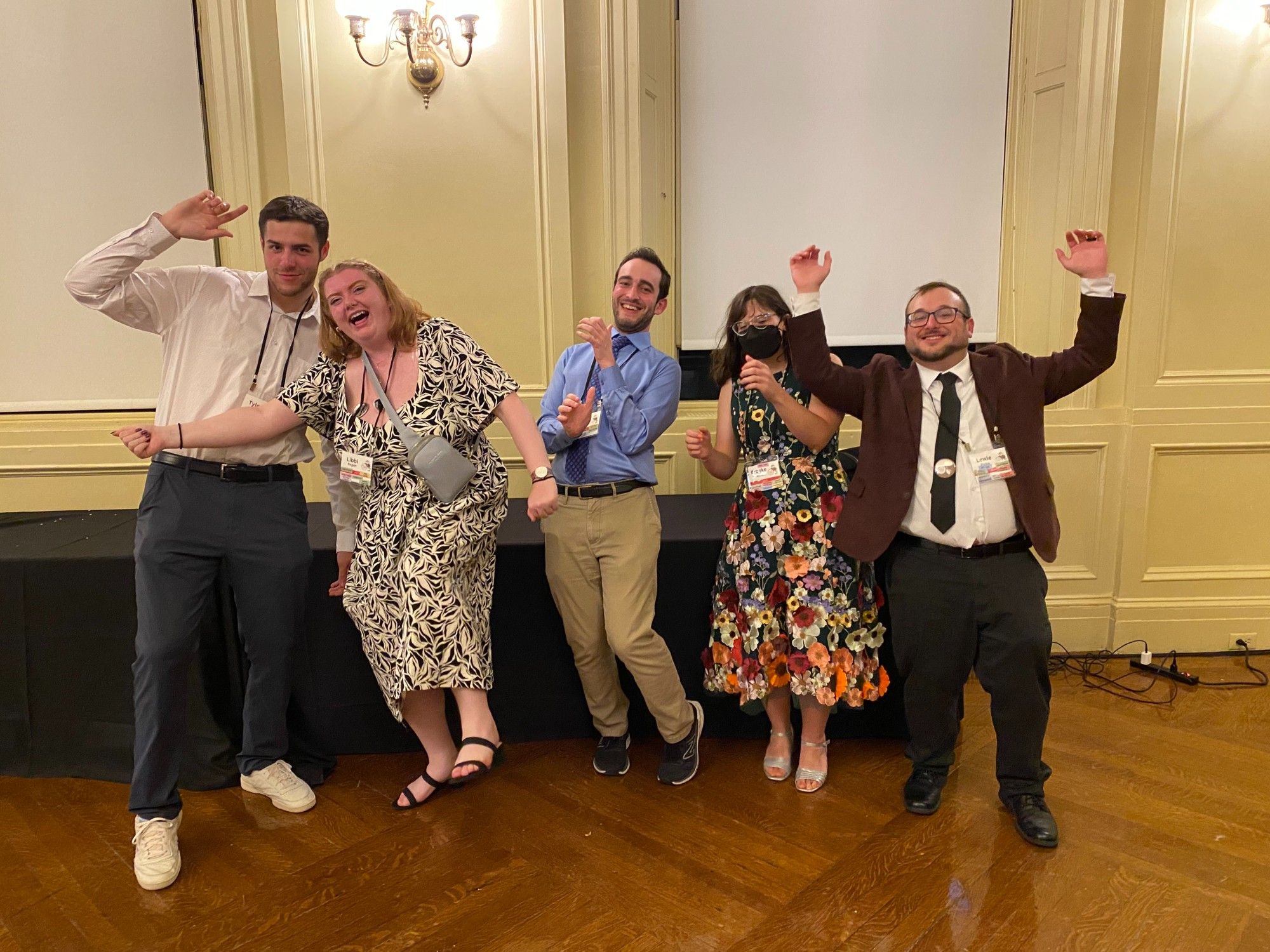 Five people in formalwear dancing