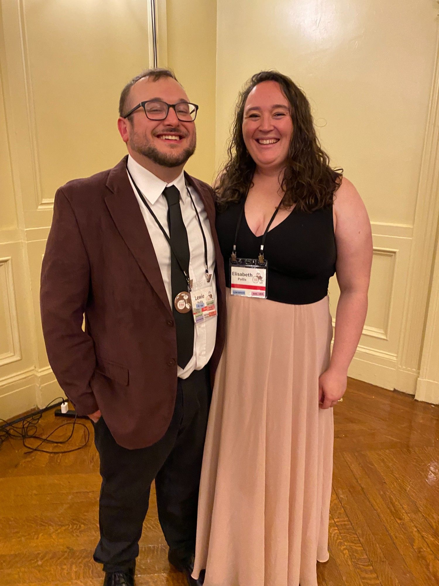 Two people in formalwear smile for the camera