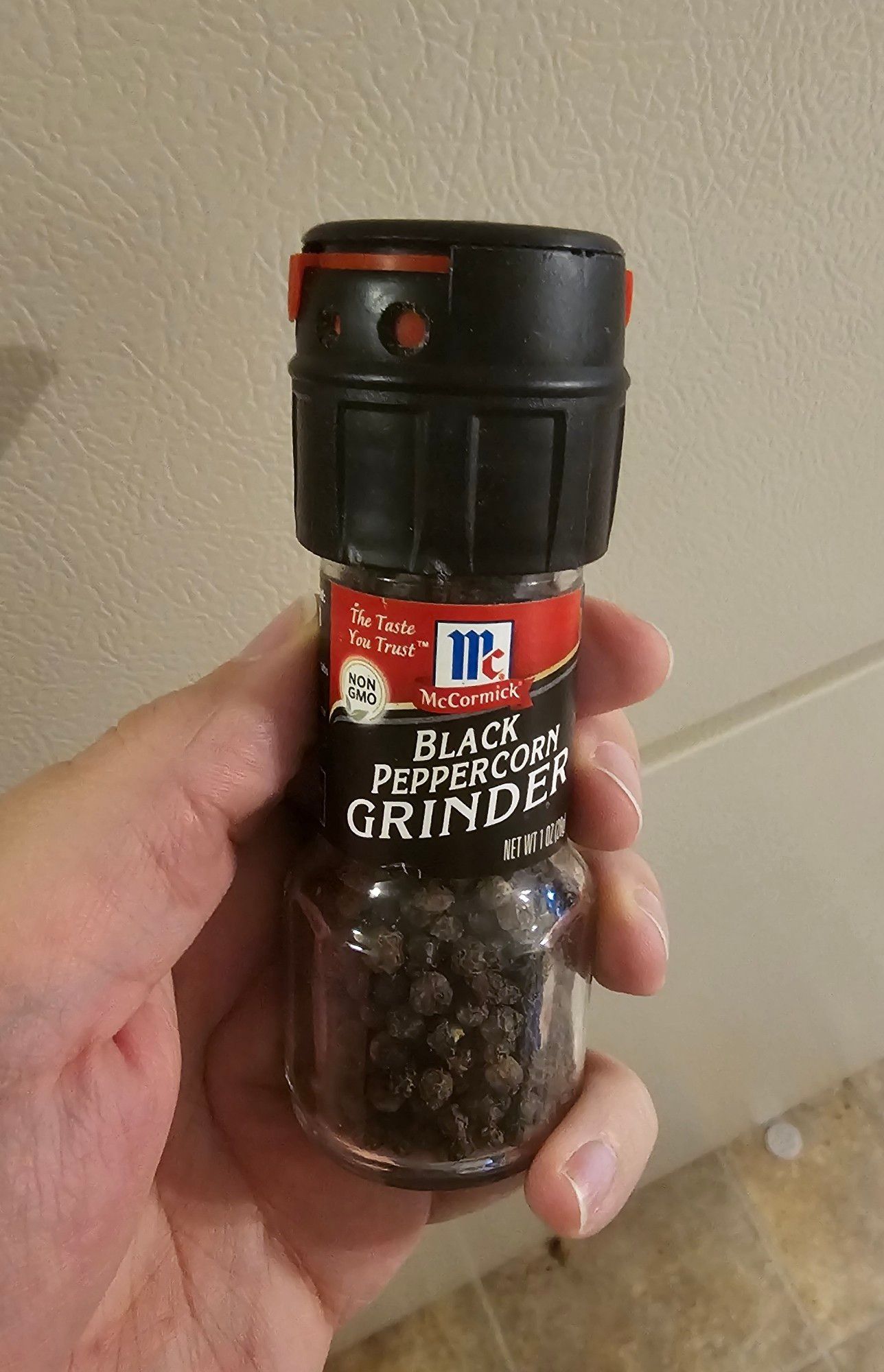 McCormick black pepper corn grinder with lid on