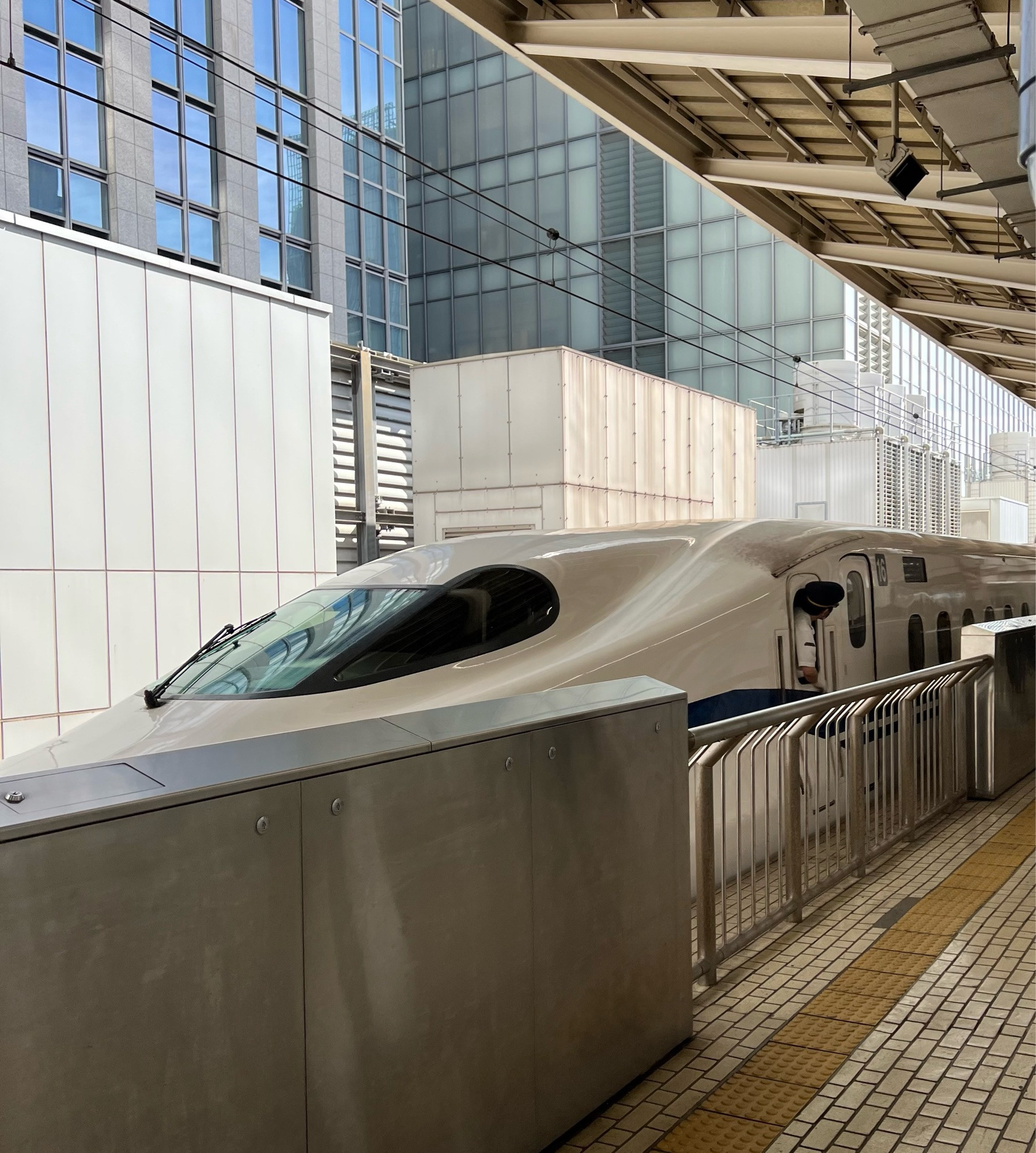 The Shinkansen in the station at Tokyo, looking ridiculously sleek behind its safety barrier