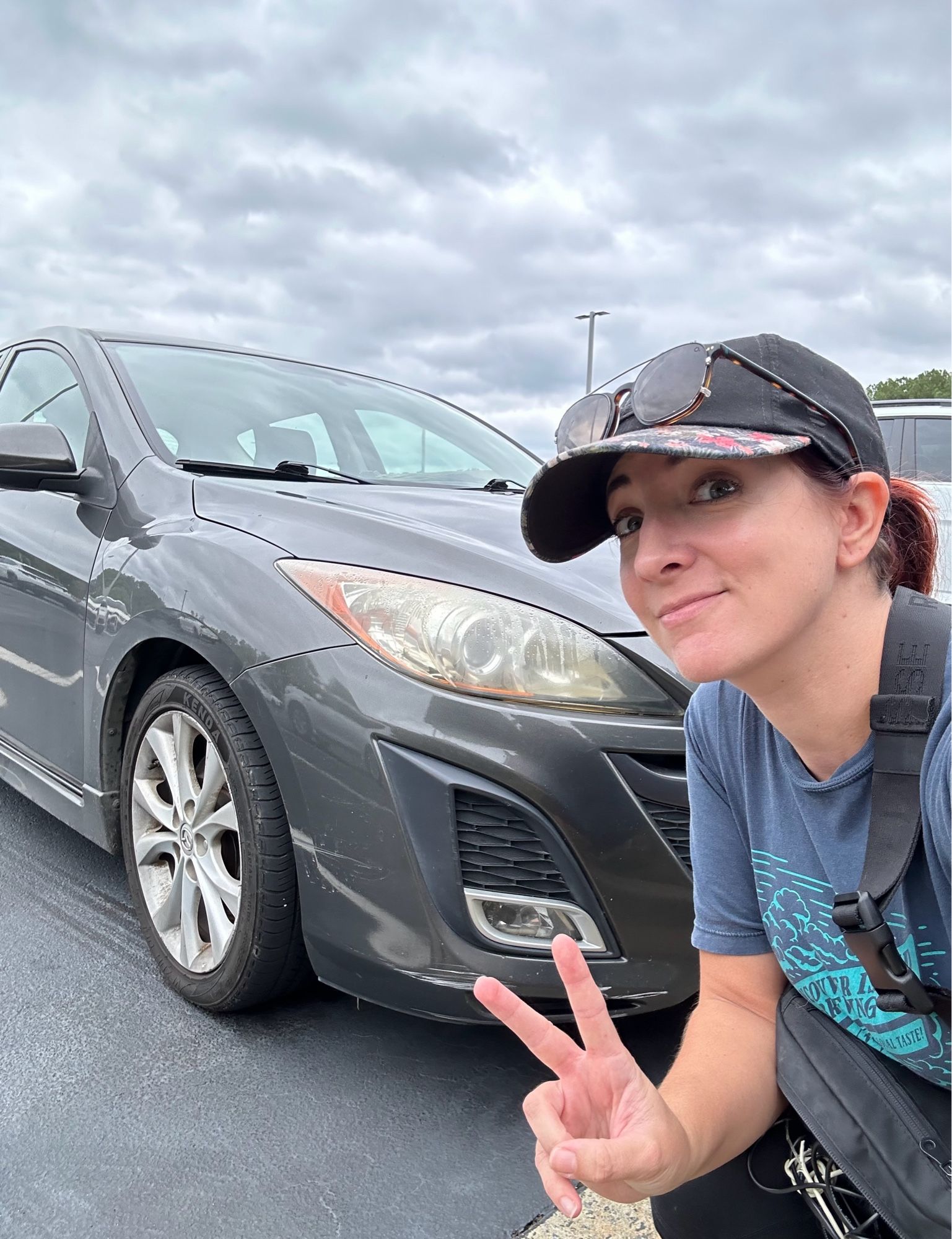 Me posing in front of my grey 2010 Mazda3