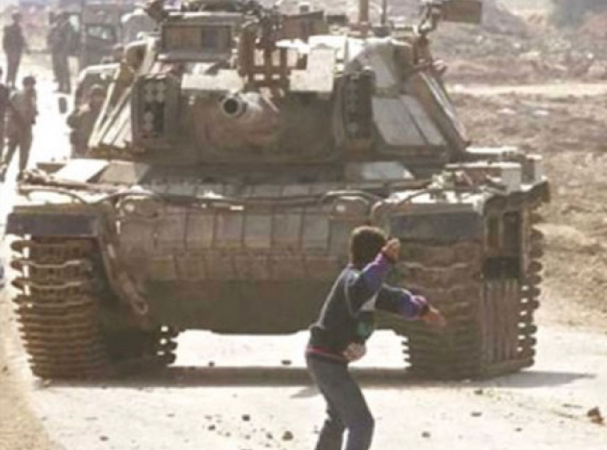 Iconic photograph captured by Laurent Rebours for the Associated Press. Faris Odegaard is a 14 year old Palestinian kid standing in front of an Israeli tank in the middle of throwing a rock. The photograph is from behind so Faris’ face isn’t visible.