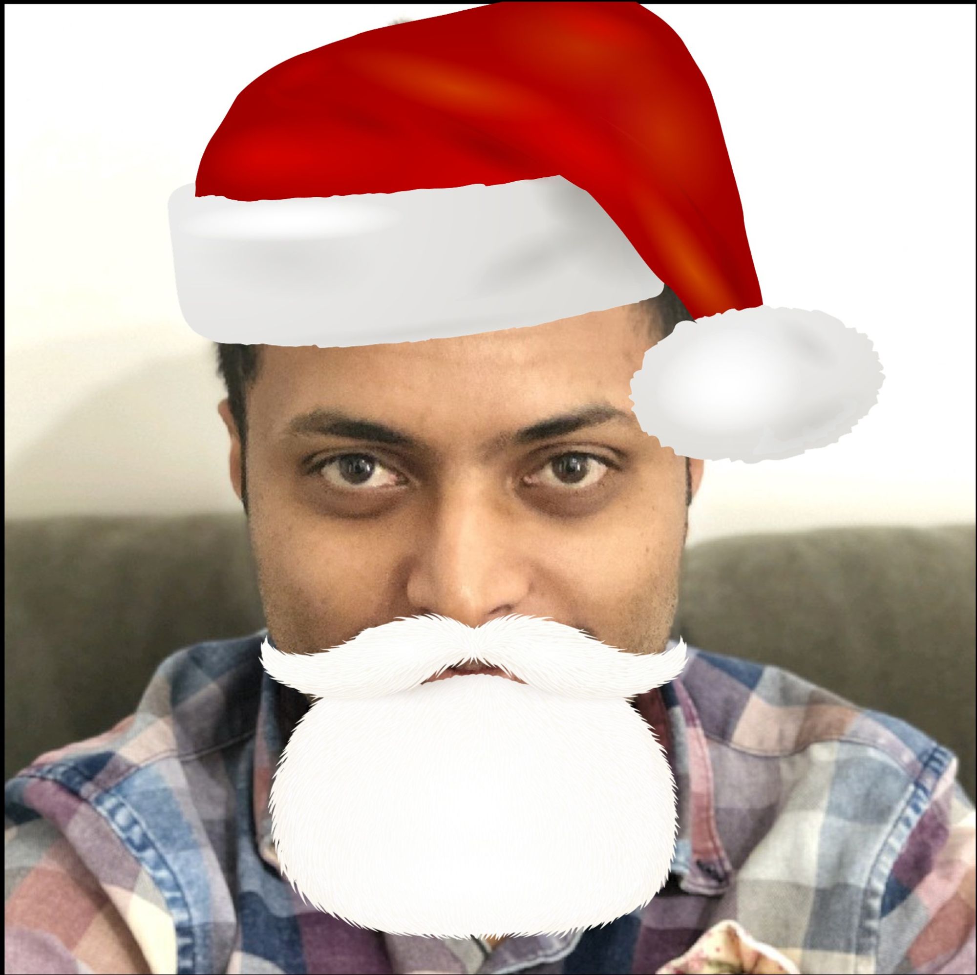 A man cheerfully disguised as Santa Claus, complete with a red hat and white beard. This Santa is more than just merry; they're a Lead Quality Coach at Culture Amp. A known figure in the testing community, they've shared their insights at conferences like Ministry of Testing's Testbash and Saucelabs' Saucecon.