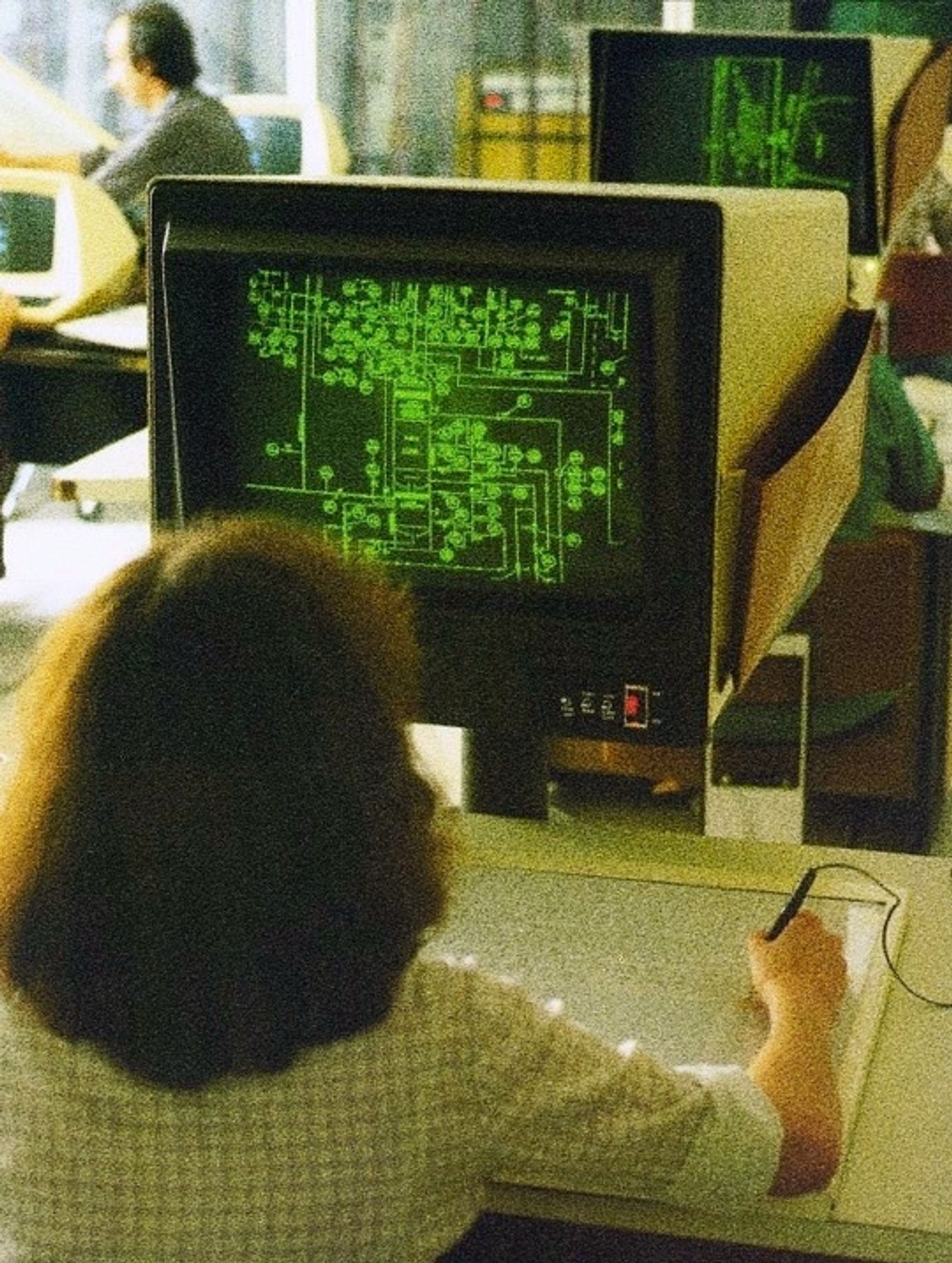 Computervision CADDS-3 system, c. 1979.

a woman sitting at a large phosphor green monitor using a primitive drawing tablet to generate a complex grid of squares and lines