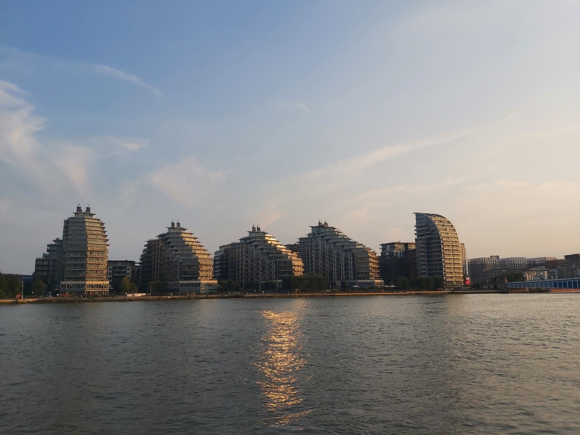 River with cascading water side apartments on the other side