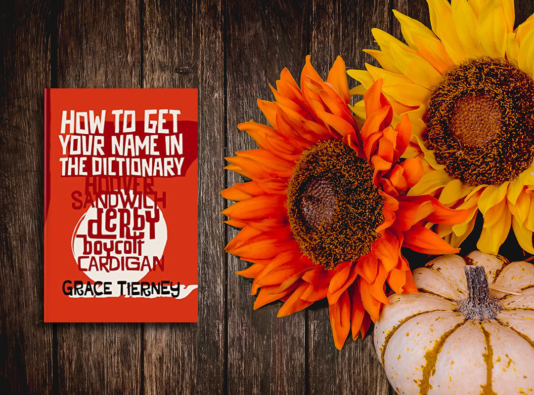 "How to Get Your Name in the Dictionary" by Grace Tierney in paperback beside some sunflowers and a pumpkin. It's a book about eponyms and toponyms, words named for people and places.