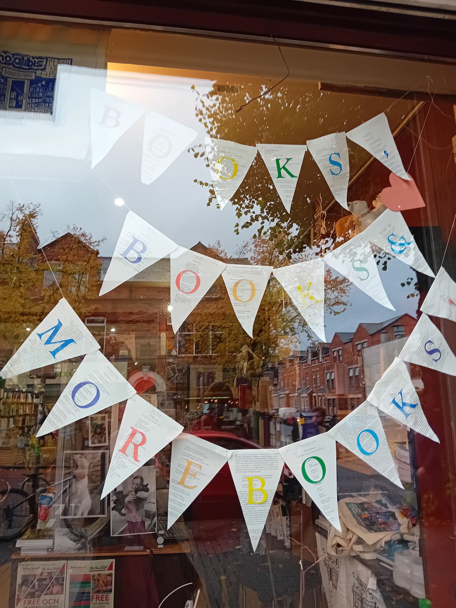 Bookshop window, No Alibis bookstore in Belfast, with More Books in bunting flags