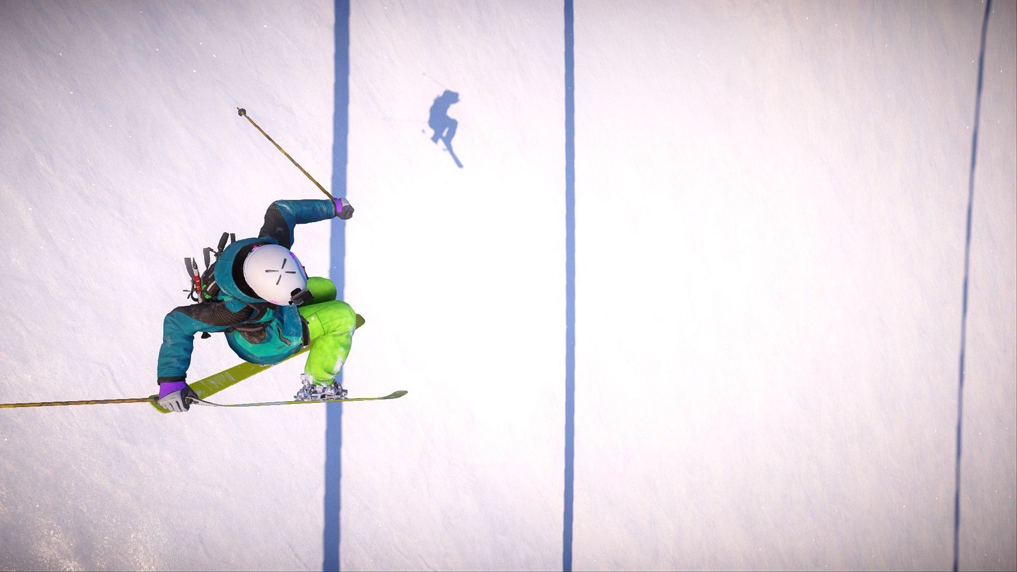 A skier holding a cuban tail grab as seen from above with her shadow appearing in the middle of the two parallel shadows of cables.