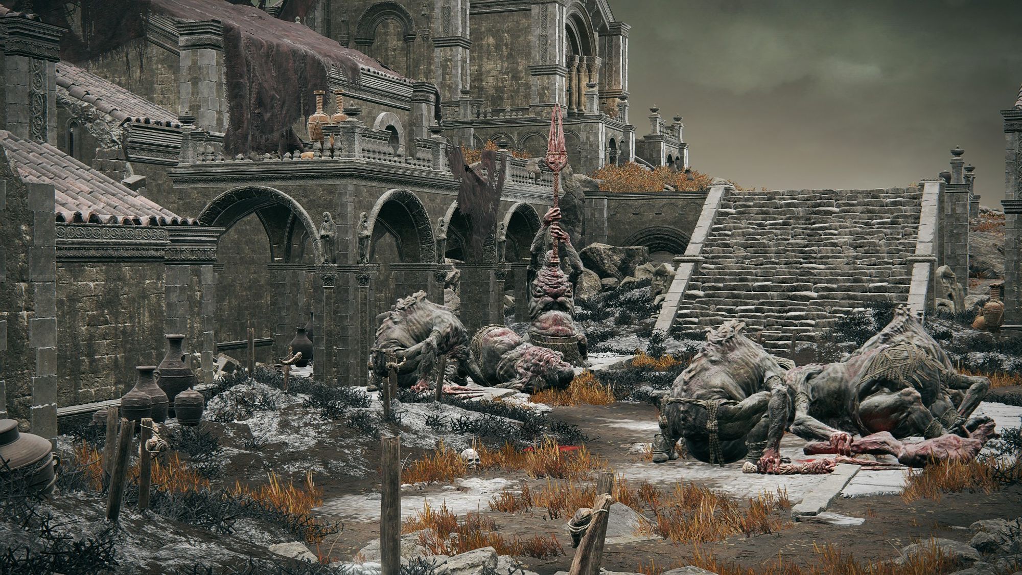 Elden Ring: Shadow of the Erdtree DLC screenshot; a gathering of Bloodfiend ogres sitting in Prospect Town. They are all eaten bits of legbones of their fallen bretheren and a lone ogre in the back is holding aloft a red, flaming fork of some power.