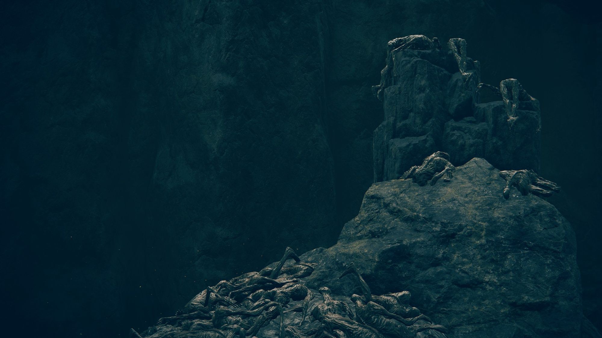 Elden Ring: Shadow of the Erdtree DLC screenshot; a rocky outcropping in the river below Gravesite Plain. It is piled with bodies that looked dashed upon the rocks, as if they were carelessly chucked there from a height after being discarded.