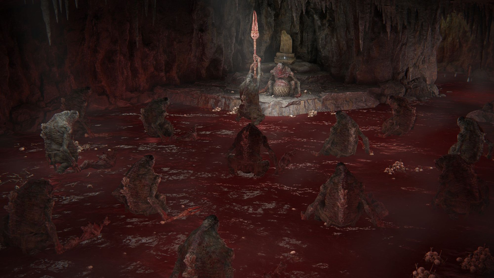 Elden Ring: Shadow of the Erdtree DLC screenshot; a gathering of Bloodfiend ogres sitting deep in a dark cave, in a pool in ankle-high blood. One at the far end is raising a bloody, red fork aloft and praising another ogre sitting in front of them on a plinth.