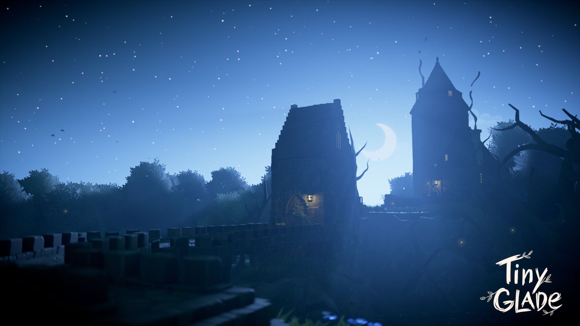 Tiny Glade screenshot showing a grassy, ruined bit of stonework with a full walkway that curls to a gatehouse and then to a mysterious tower on a hill. A crescent moon hangs behind the tower, magically, and spills moonlight so much into the frame that most of the buildings are left in shadow, with only lanterns breaking up the silhouettes.