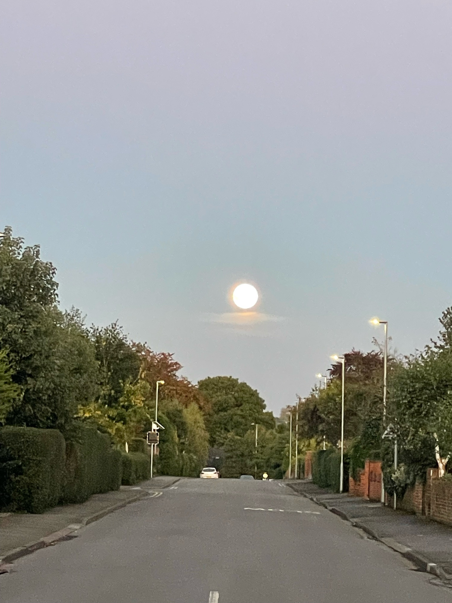 Low moon at the end of a street taken with an iphone