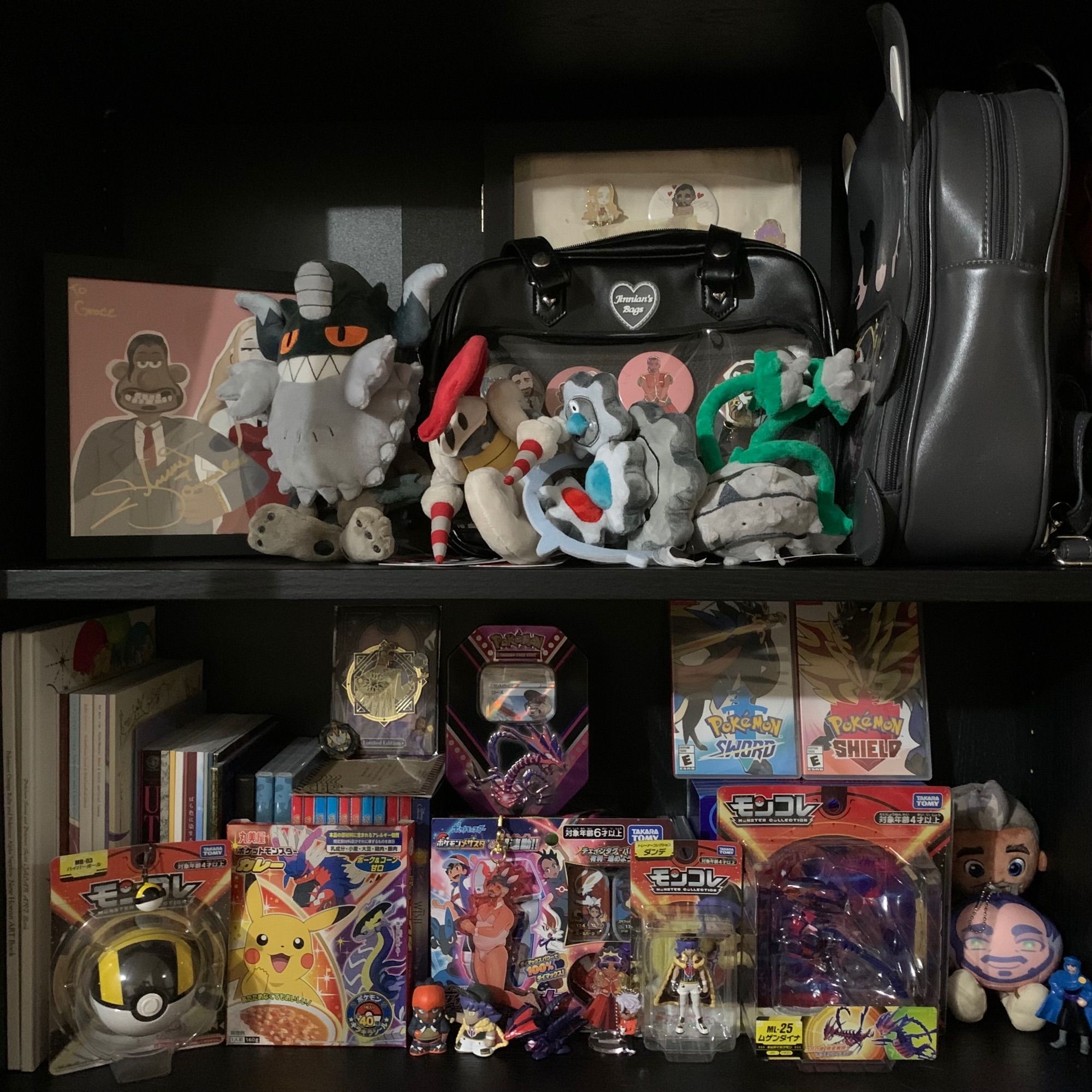 Two rows on a shelf dedicated to Chairman Rose and Pokemon collectibles, including plushies of his Pokemon, doujins, fan merch, cards, and an autographed drawing from his VA.