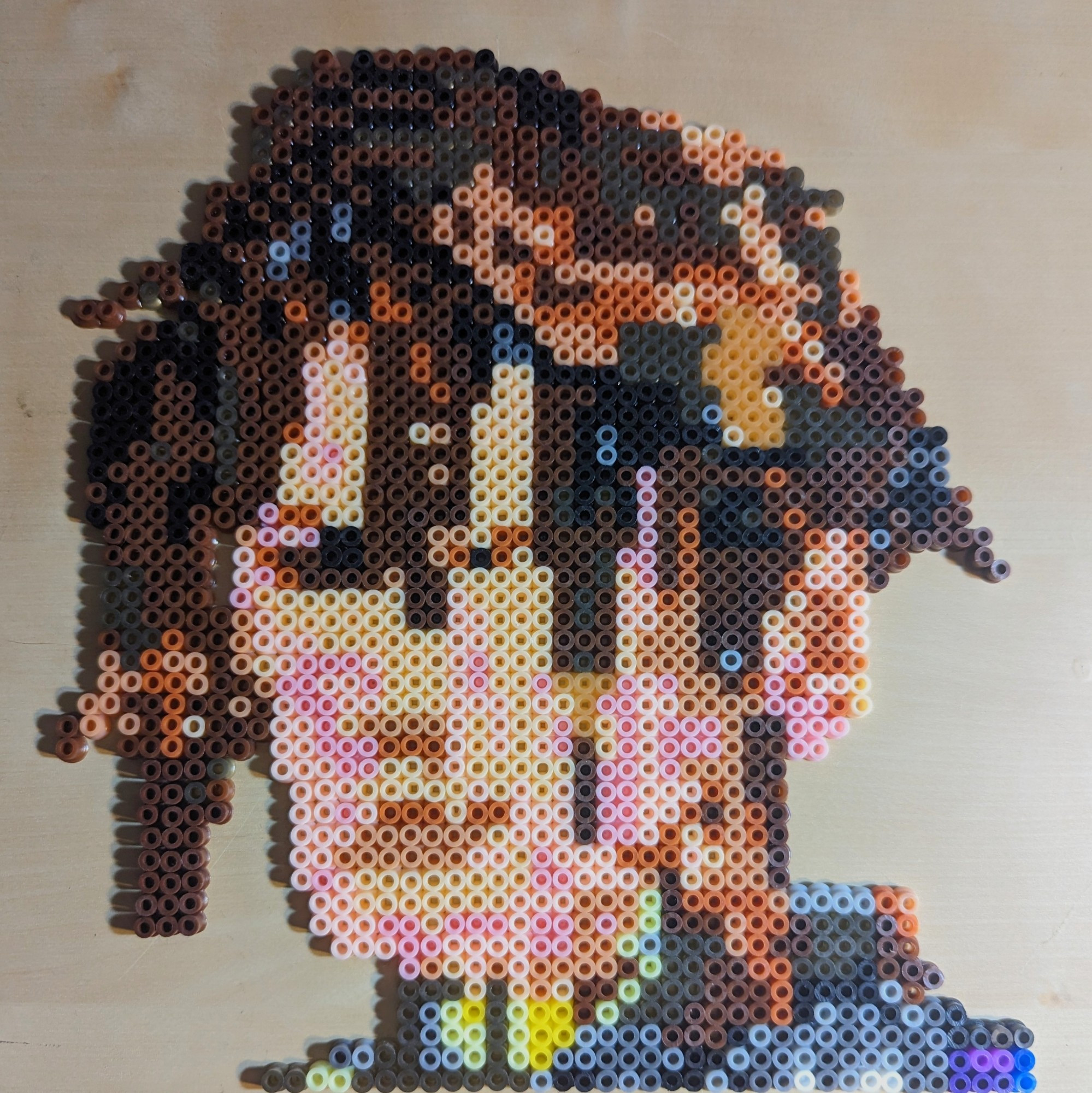 A pixel for pixel perler replication of Squall's face from the original version of FFVIII when he and Rinoa first meet and she declares him the best looking guy here. The aggressive angles and poorly defined features make him look like a melted nightmare but she's probably still right. 