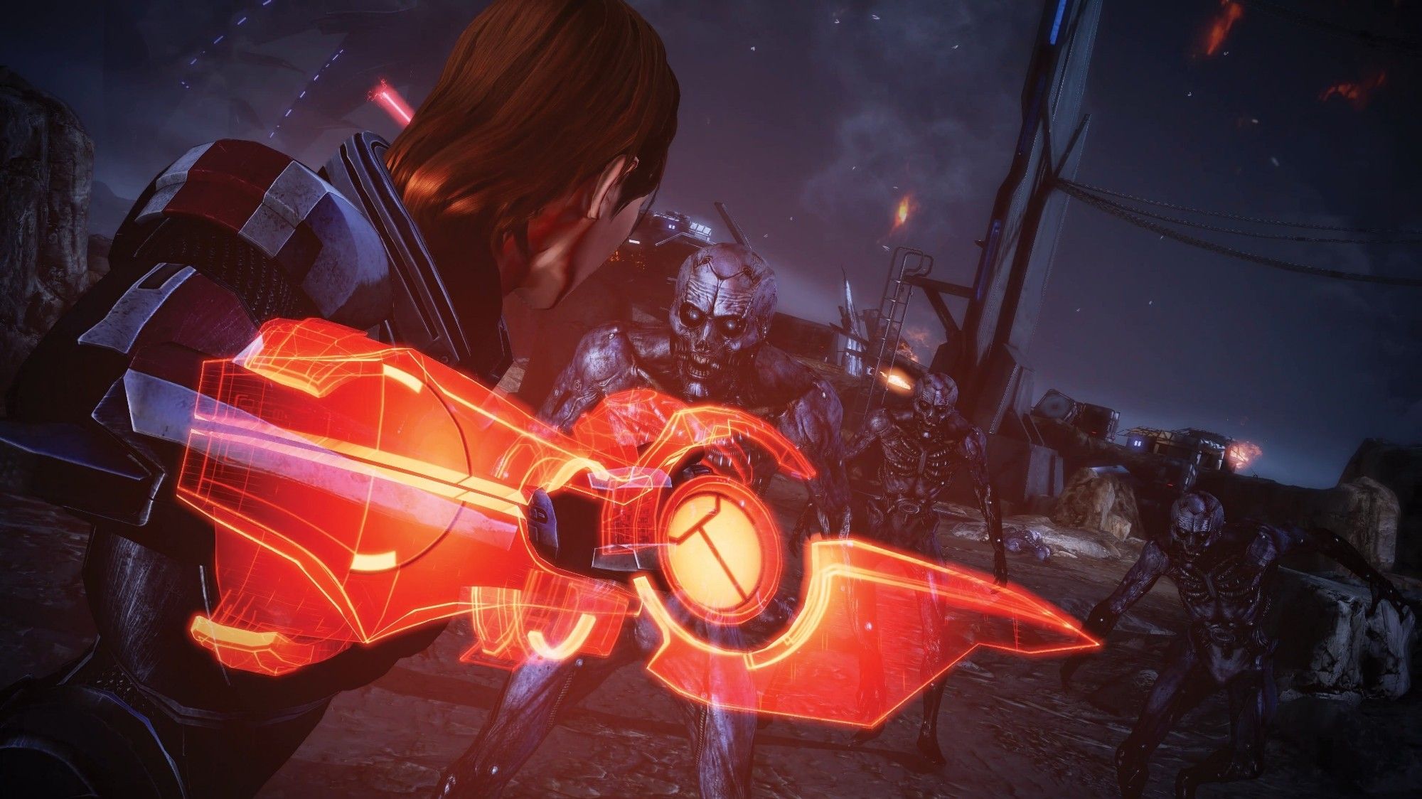 A red headed Commander Shepard readies her Omni-blade for an encounter with husks; humans transformed into mindless zombies.