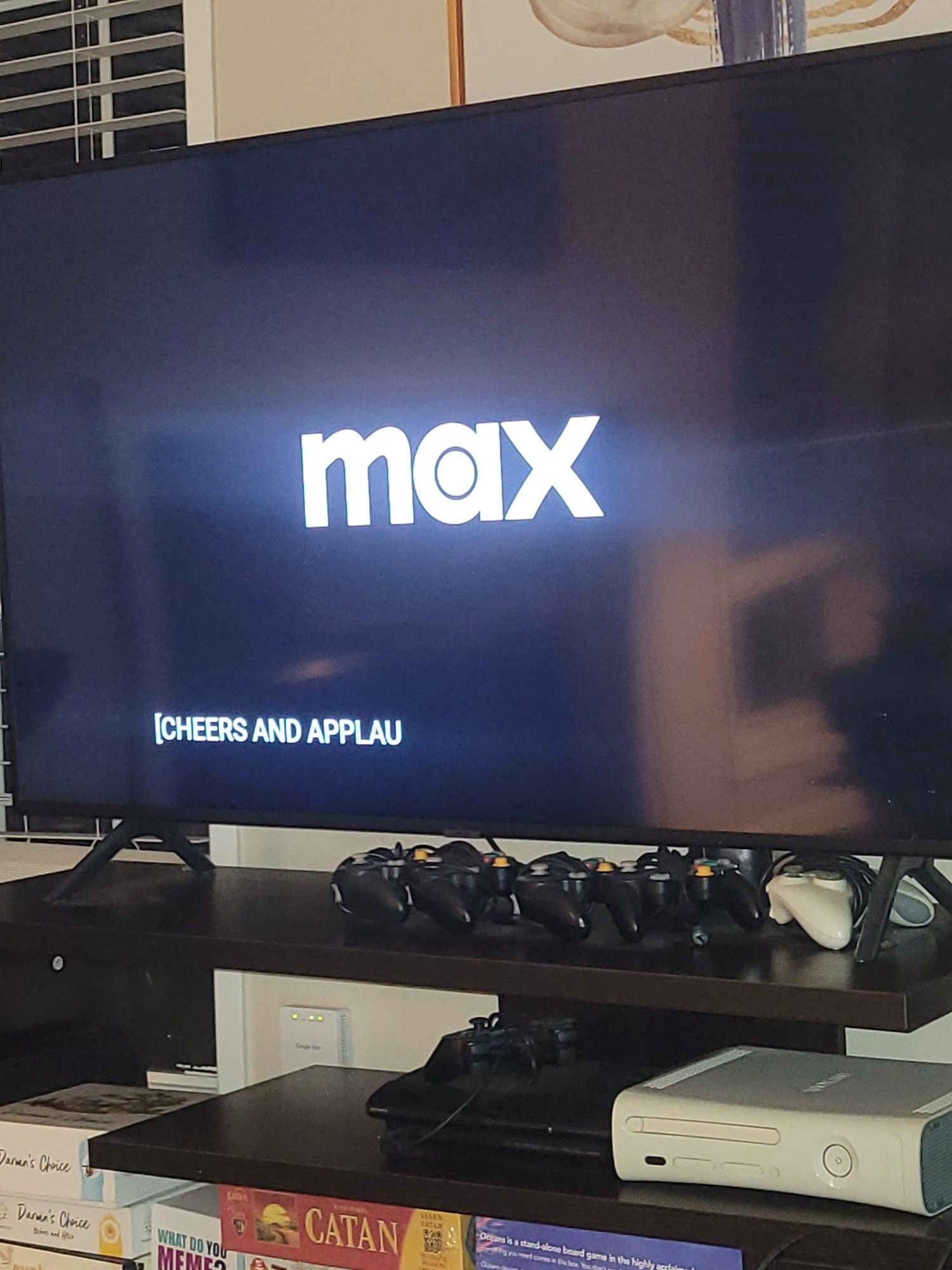 Screen with the "max" logo with subtitles of "CHEERS AND APPLAU"