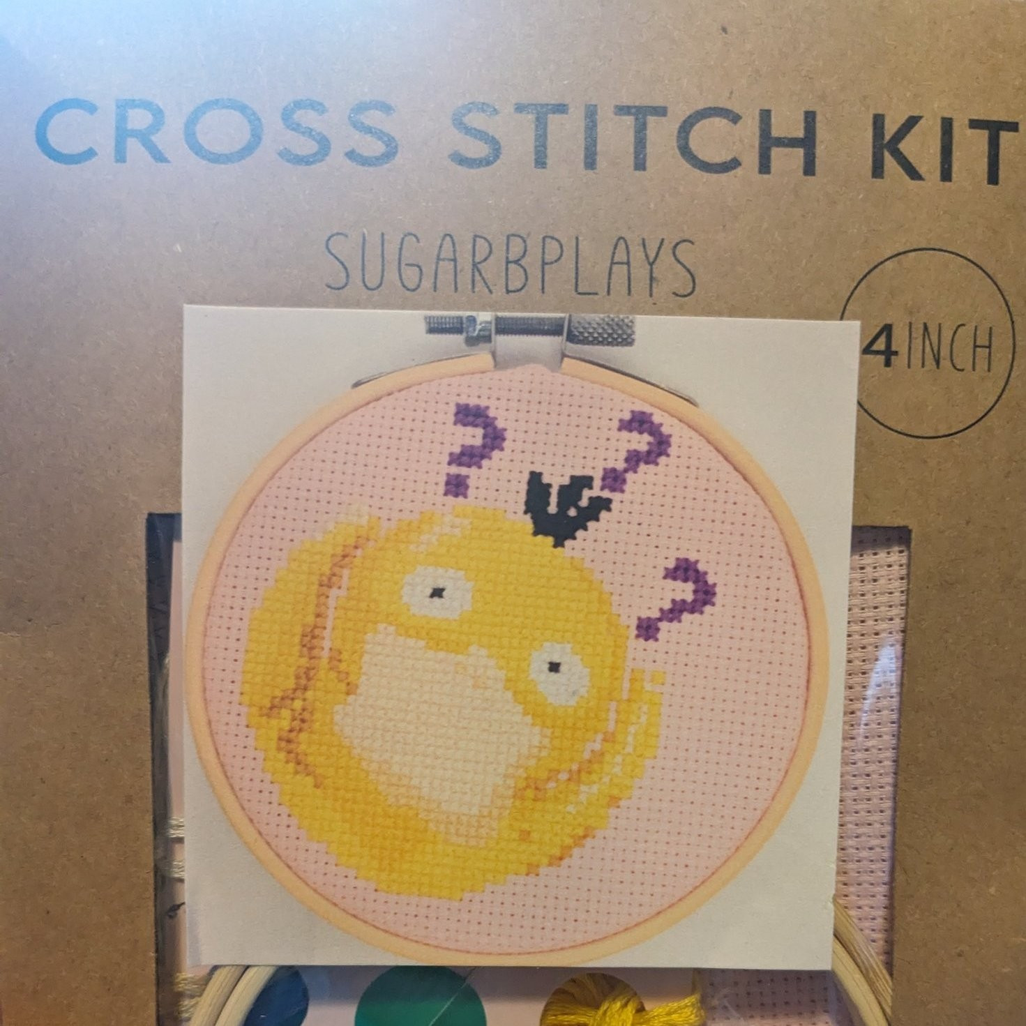 A cross stitch kit by SugarBPlays: Psyduck holding his head with question marks surrounding him