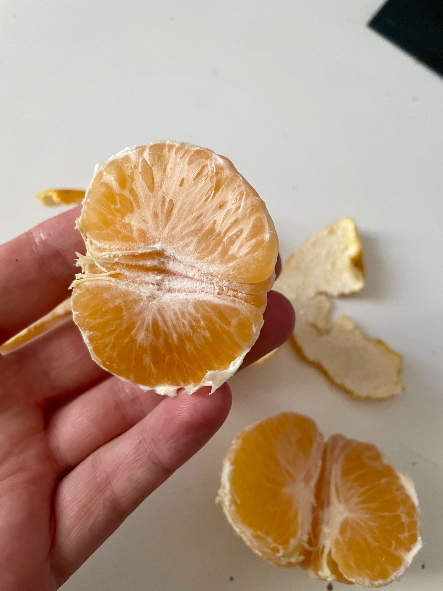 Two halfs of a peeled mandarin.