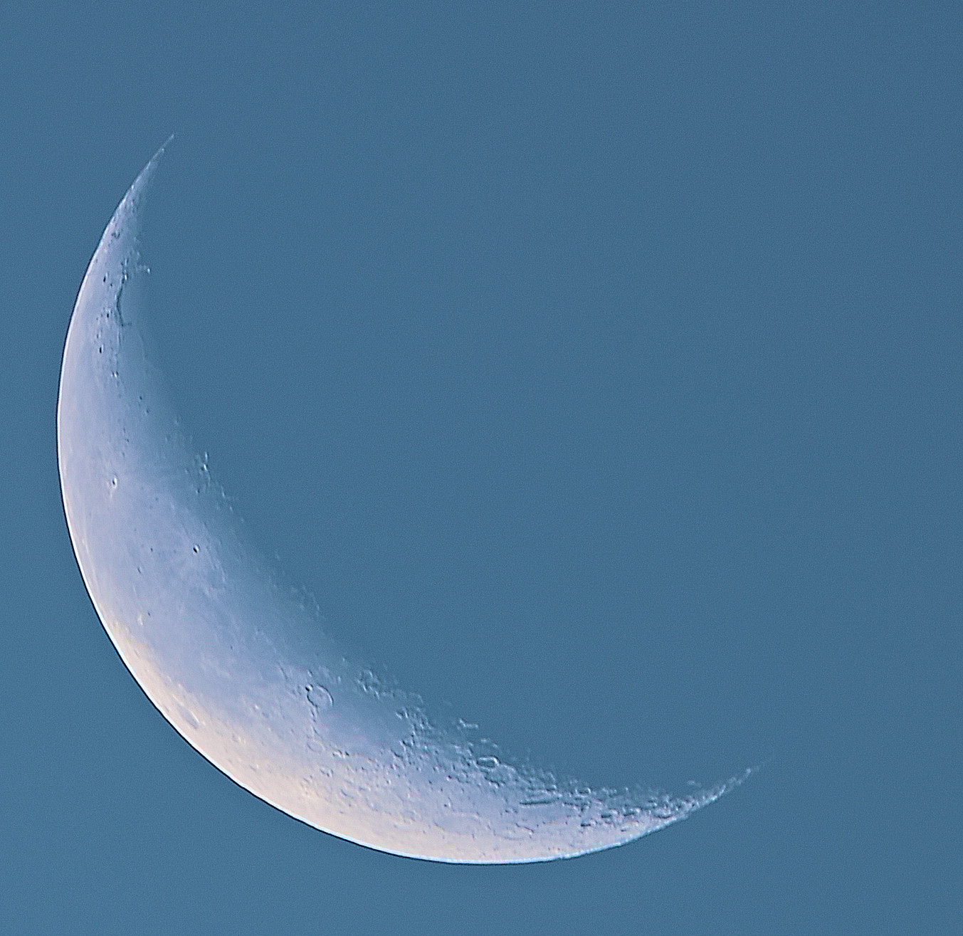 Stacked image of Crescent Moon against morning blue sky