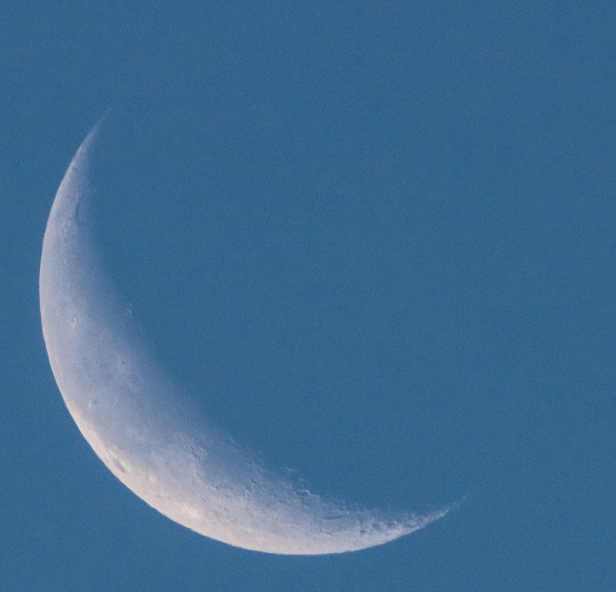 Image of Crescent Moon against morning blue sky